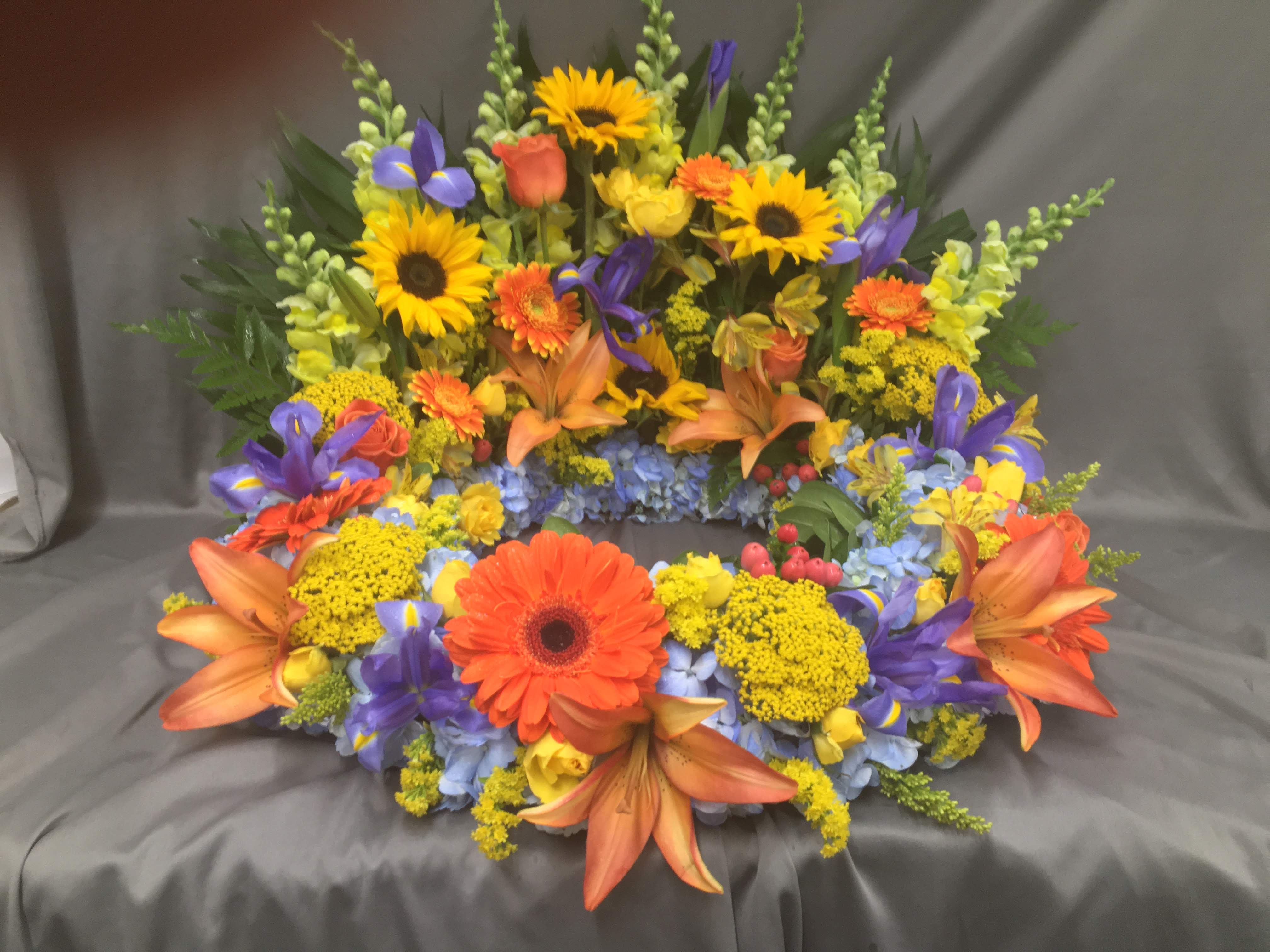 Eternal Wreath for Male - Seasonal Assortment of flowers arranged in a wreath with opening for Urn or Picture. 