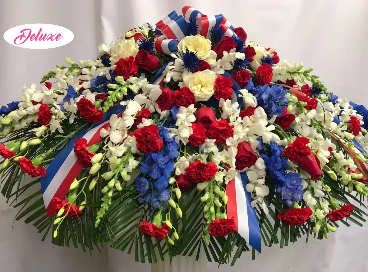 Patriotic Casket Cover Patriotic Casket Cover - Red, White and Blue for the true patriot. This beautiful casket cover is a lovely way to honor the memory of a loved one that served our country or simply just loved the U.S.A. Flowers are seasonal and may vary.