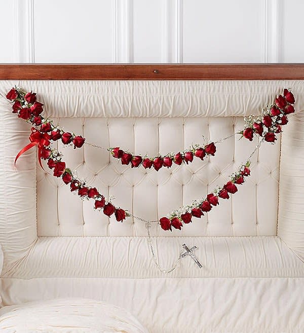 Large Rosary with Red Spray Roses Large Rosary with Red Spray Roses - Express the faith, hope and love they inspired with a beautiful ornamental arrangement for the casket. Crafted by our caring florists from a dozen fresh red roses and a string of rosary beads, then accented with baby’s breath and a satin ribbon, this thoughtful adornment is a touching way to celebrate their devotion.
