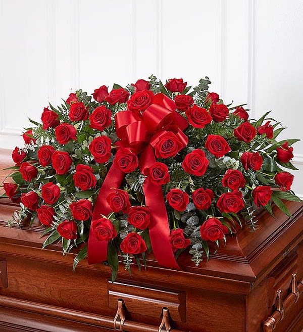 Red Rose Half Casket Cover - When someone near and dear to us passes, it’s natural to want to express all the love and admiration we have in our hearts. Nothing conveys this better than a  classic display of red roses. Our half casket cover, crafted with care and artistry by our expert florists with over 50 premium red roses, fresh greenery, and accented with a red satin ribbon, is an unforgettable way to commemorate a lifetime of esteem and adoration.