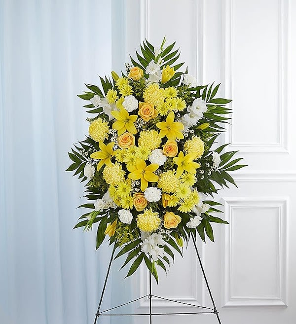 Yellow &amp; White Sympathy Standing Spray - A ray of hope can mean everything after the loss of a loved one. Both bright and abundant, our impressive standing spray arrangement, meticulously handcrafted by expert local florists with sunny yellow and rich white blooms, offers a grand gesture of peace, comfort and light during a difficult time.