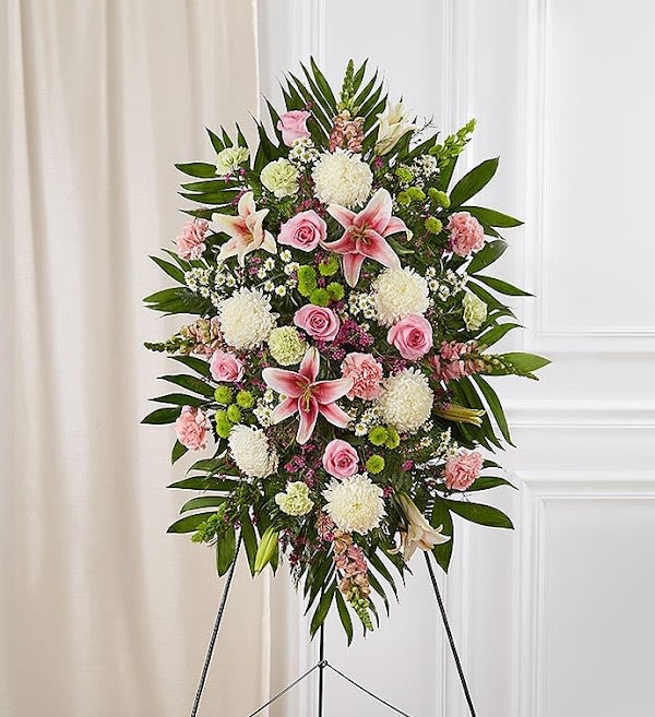 Pastel Sympathy Standing Spray - When we celebrate the life of a loved one, we honor their memory through heartfelt words and gestures. Our classic standing spray arrangement creates a graceful tribute, crafted with soft pastel blooms for a lush, full presentation. What a special way to remember someone so very loved.