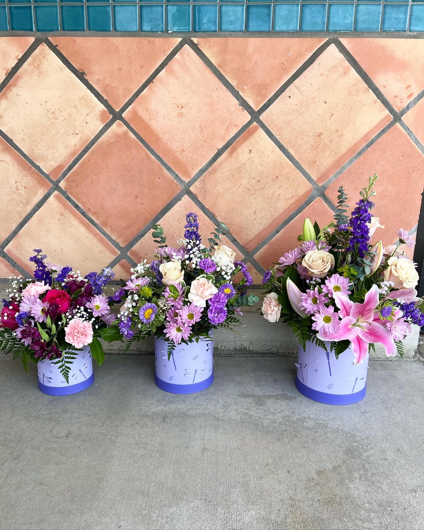 magical dragonfly bouquet - pink and purple flowers arranged inside a flower box with dragonfly on it. 