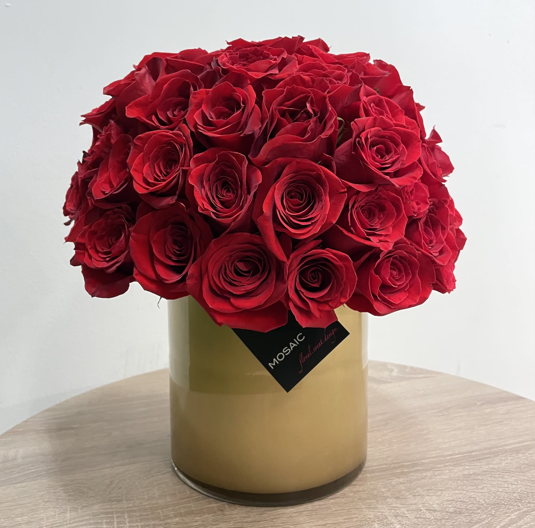 Hollywood Glam - 50 red roses arranged in an 6&quot; diameter custom painted gold vase. The arrangement stands at about 12&quot; high.