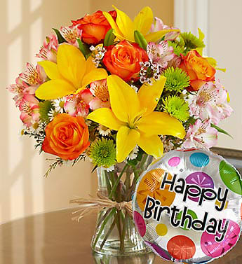 Fields of Europe Happy Birthday - Product ID: 90981  Get their party started with our elegant, hand-designed bouquet of fresh roses, lilies, alstroemeria, poms and more, arranged by our florists inside a stylish clear glass vase tied with raffia as a nod to rustic European style and paired with a festive &quot;Happy Birthday&quot; balloon. Gorgeous gathering of roses, lilies, alstroemeria, poms, waxflower, monte casino and salal Artistically designed by our select florists in a clear glass gathering vase tied with raffia; vase measures 8&quot;H Arrives with an 18&quot;D Mylar &quot;Happy Birthday&quot; balloon; design on balloon will vary due to local availability Large arrangement measures approximately 20&quot;H x 16&quot;W Medium arrangement measures approximately 18&quot;H x 15&quot;W Small arrangement measures approximately 16&quot;H x 14&quot;W Our florists hand-design each arrangement, so colors, varieties, and container may vary due to local availability Lilies may arrive in bud form and will open to full beauty over the next 2-3 days