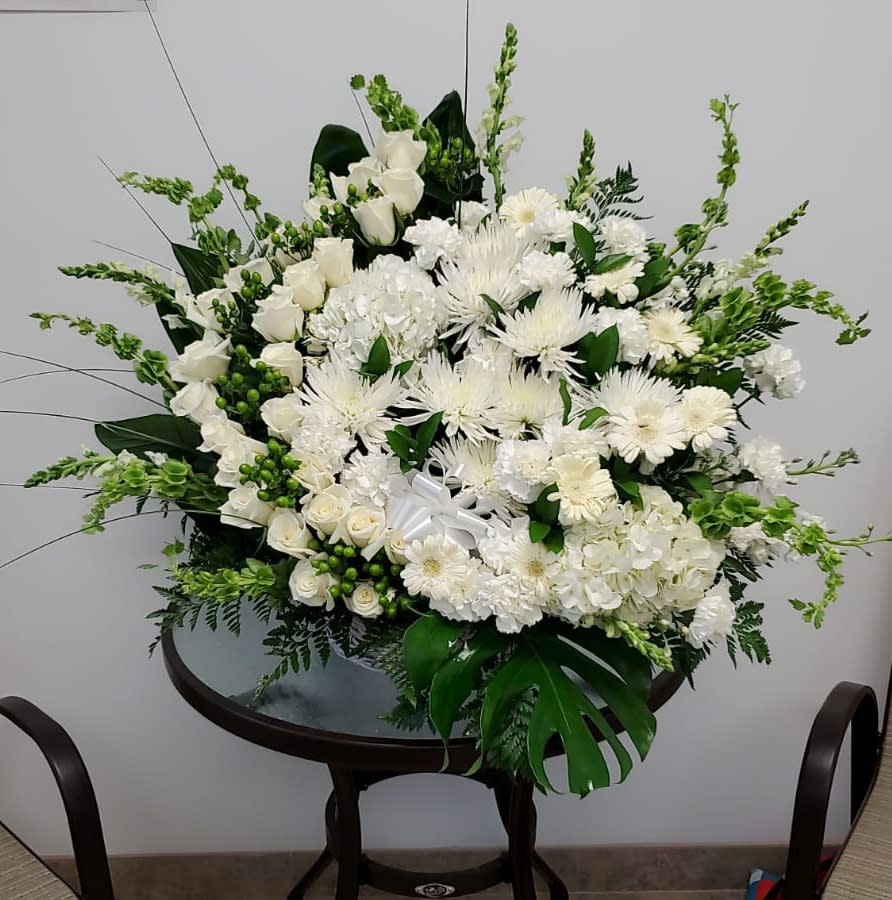 Sympathy arrangement - Beautiful funeral arrangement with roses, daisies and white spiders  Flowers and similar colors