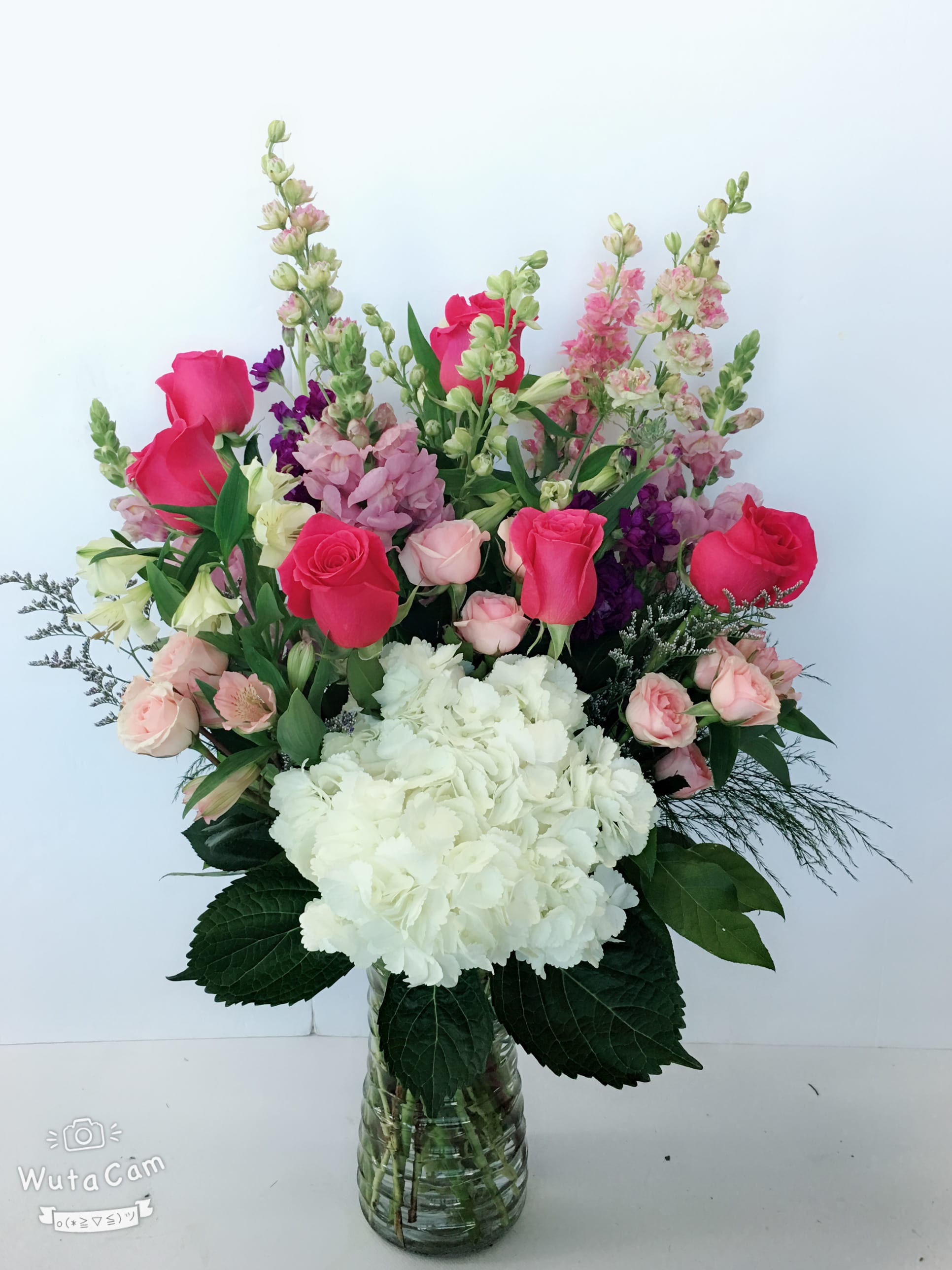 The Perfect Blooms Bouquet  - This arrangement is perfect for anyone who's passionate about purple and pink. So full of majestic beauty.  Gorgeous hydrangea, hot pink roses, pink spray roses, stocks, snapdragons, larkspurs, alstroemerias with lemon leaf and greens in a clear glass vase. Orientation: One-Sided Approximately 22&quot; H x 15&quot; W   Orientation: All-Around