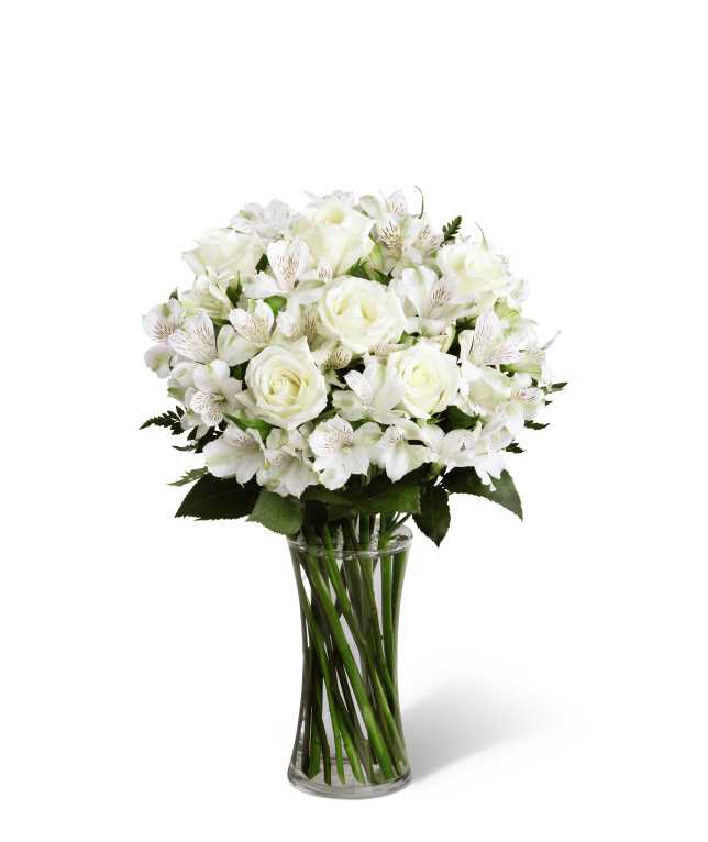 The FTD Cherished Friend Bouquet - The FTD Cherished Friend Bouquet offers comfort and sympathy in the time of grief and loss. Bright white roses and Peruvian lilies are accented by lush greens and gorgeously arranged in a clear glass gathering vase to create a bouquet that will bring peace and show how much you care.