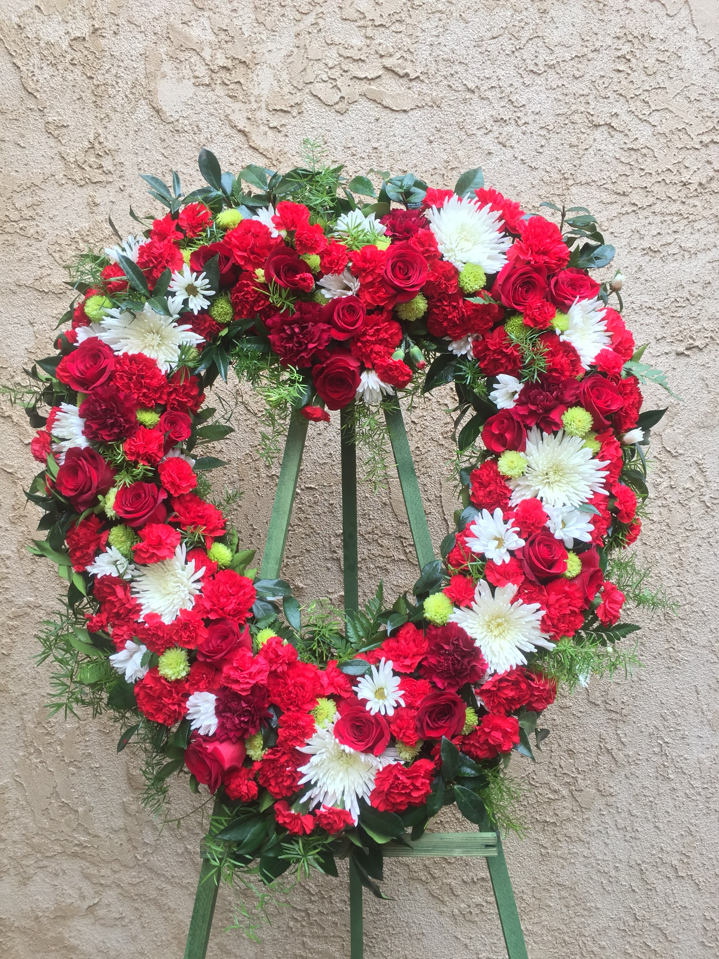 Heart Spray 1 - Funeral heart-shaped spray with red and white flowers.