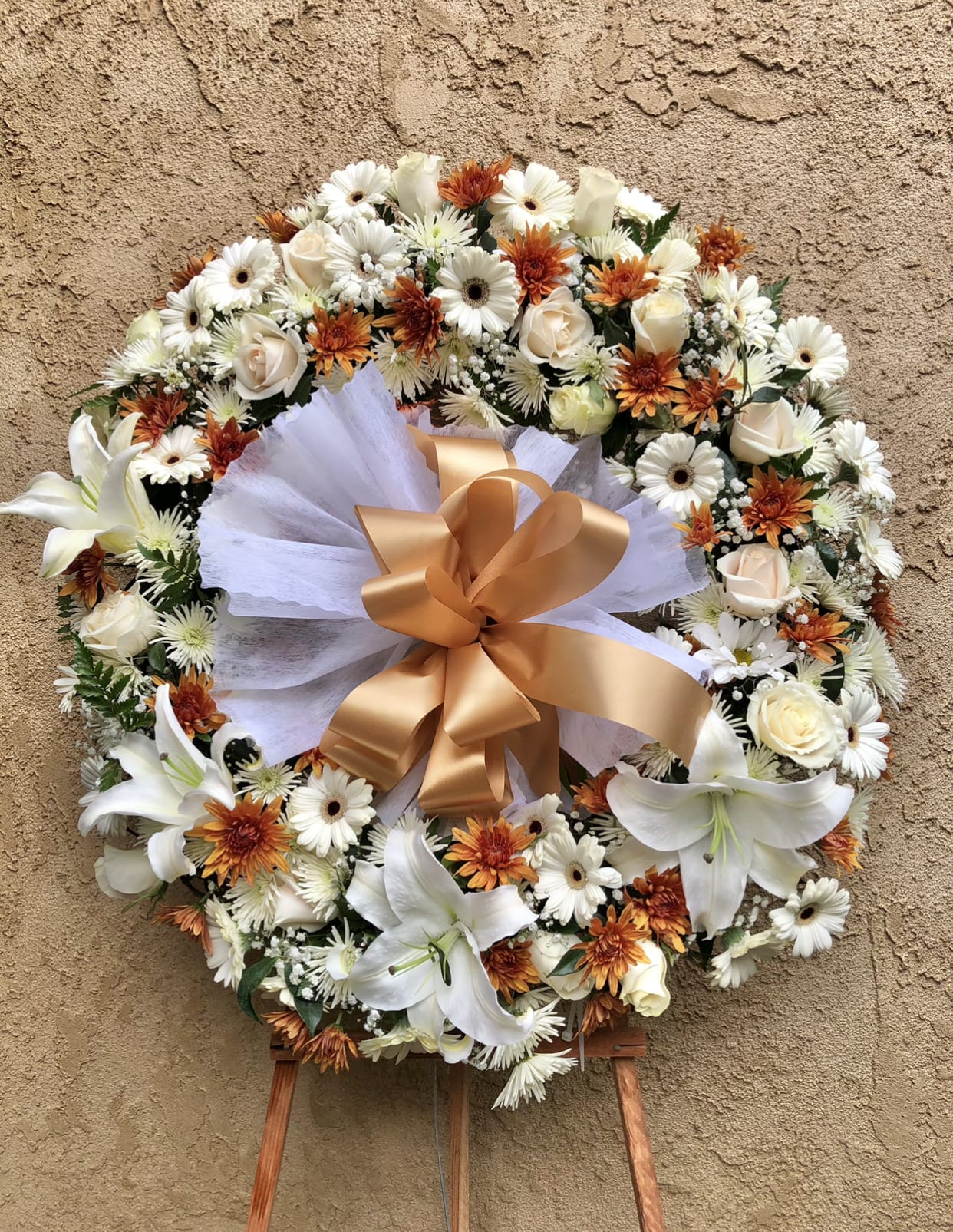 Rustic Spray - Beautiful funeral spray arrangement with white roses, lilies, daises, orange chrysanthemums, with green and white accents
