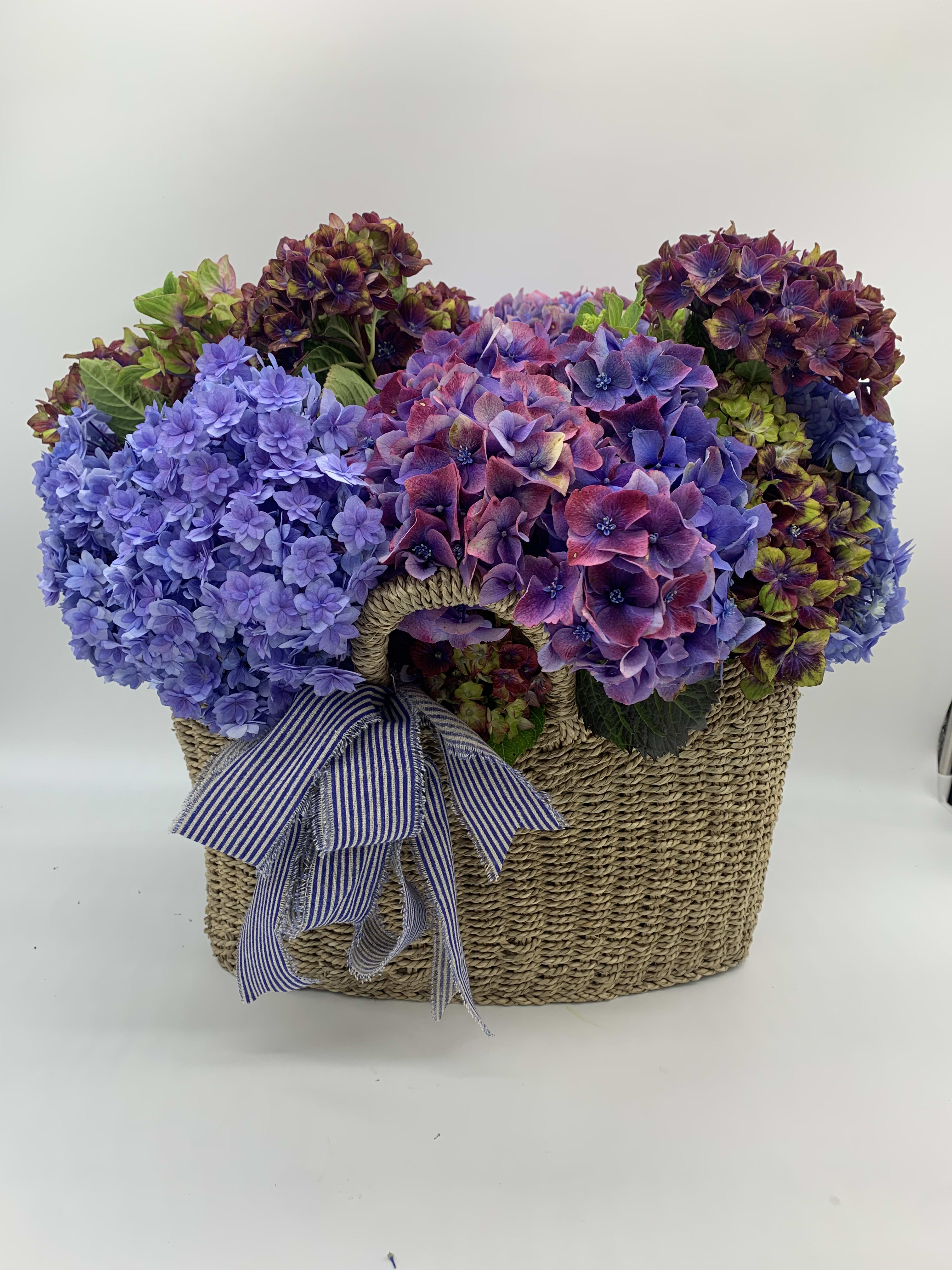 My basket - This beautiful piece is made with 15 hydrangeas mixed of different colors , sitting in a beautiful wooden basket reusable 14x16 let’s made her or they house extremely beautiful. 