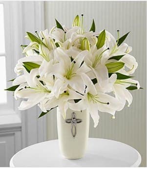  Faithful Blessings™ Bouquet - Faithful Blessings™ Bouquet is an incredible way to celebrate a communion, confirmation, or wedding, as well as send your sympathy for the loss of a loved one. Bringing together stems of fragrant Oriental Lilies, boasting multiple blooms on each stem to create a full and lush flower bouquet, this offering of flowers will bring peace and beauty to any of life's special moments and occasions. Presented in a keepsake designer white ceramic vase with a stunning cross on the front, this exquisite flower arrangement exudes heartfelt blessings with each eye-catching, star-shaped lily. Bouquet is approximately 17&quot;H x 16&quot;W. Your purchase includes a complimentary personalized gift message.