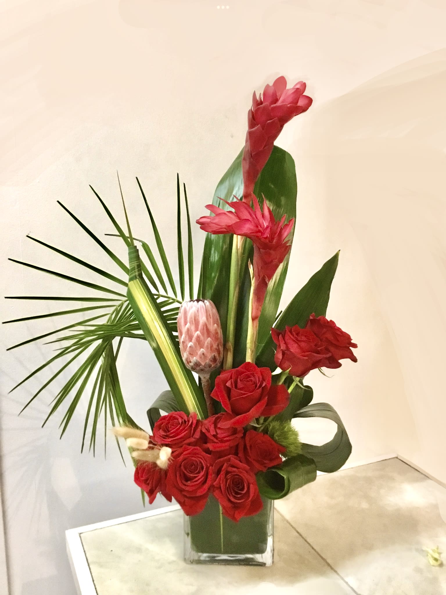 Stunning Paradise - A tropical work of art floral arrangement with protea and roses