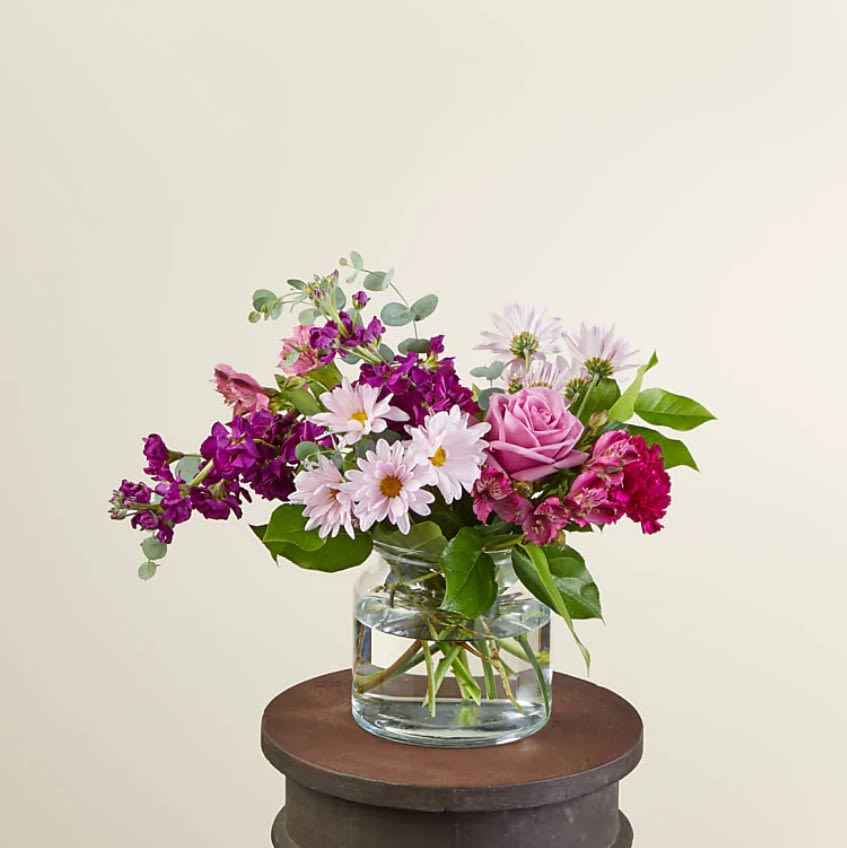 Lollipop Bouquet - Send our Lollipop Bouquet as a sweet Mother's Day treat or to an unexpecting friend. Designed with berry hues that will brighten their day and fill their room with purple carnations, lavender roses and daisies. These happy stems are paired with beautiful eucalyptus for a stunning spring aesthetic.