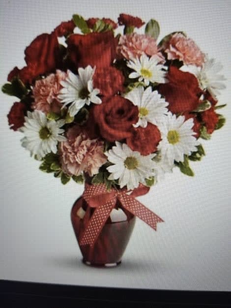 Love Is In The Air Bouquet Love Is In The Air Bouquet - This red vase is filled with red and white love flowers, She is sure to feel the love when you send this bouquet.