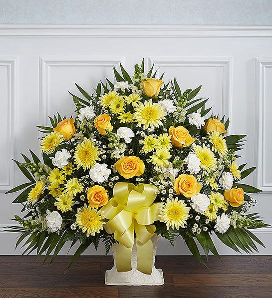 Heartfelt Tribute™ Yellow Floor Basket Arrangement - Sometimes a small ray of hope is just what is needed to get through the difficult days following the loss of a loved one. Our elegant floor basket arrangement in sunny hues, handcrafted by our caring florists with warm yellow and white blooms, is a tasteful gesture perfectly suited for the funeral home or memorial services.  Floor basket arrangement of yellow roses, cremones, carnations, and daisy poms; white snapdragons; casino; accented with soft, lush greenery Large arrangement measures approximately 36&quot;H x 38&quot;L Medium arrangement measures approximately 34&quot;H x 32&quot;L Small arrangement measures approximately 32&quot;H x 30&quot;L Appropriate for the funeral home Our florists use only the freshest flowers available, so colors and varieties may vary