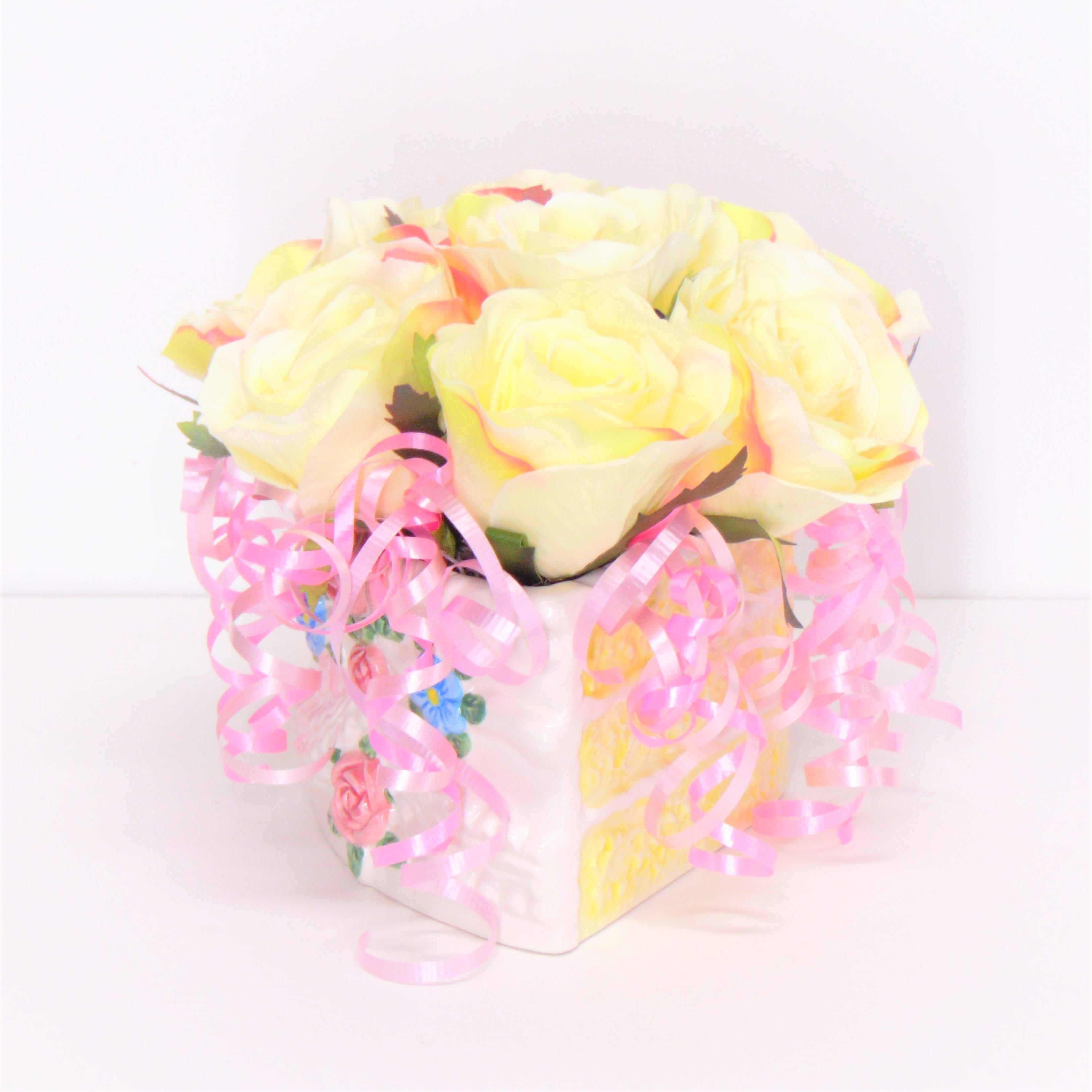 Birthday Cake Silk - A decorated porcelian cake filled with silk flowers and ribbons.