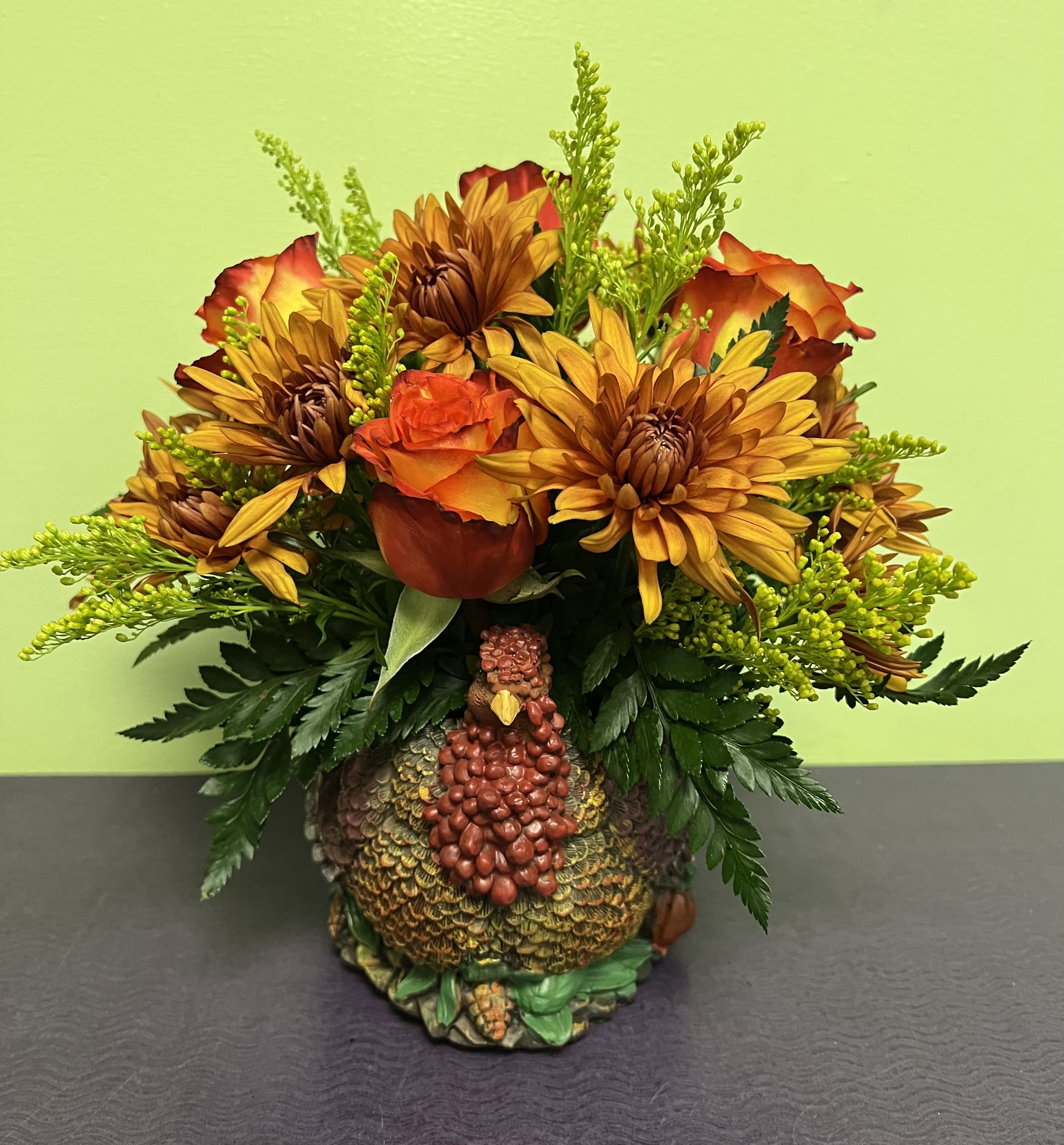 Gobble! Gobble! Gobble! - Want to give some thanks this year? Send the one you love this beautiful, one of a kind turkey planter arrangement. This ceramic turkey is hand crafted and beautifully arranged with the freshest selection of fall blooms. Make this Thanksgiving one they won't forget with this adorable creation. The actual turkey is about 6.5 inches tall with the arrangement being a bit bigger than that. 