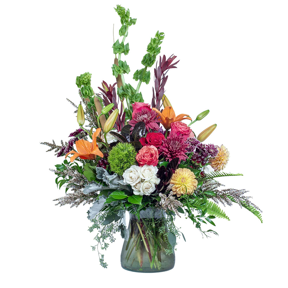 AbiBella - TMF-1437 - A lovely joy. AbiBella's unique mix of fall and holiday colors makes it the perfect gift. Brandy Roses, orange lilies, and burgundy mums elevate a hurricane vase with beauty and delight . Approximately 29&quot;W X 33&quot;H
