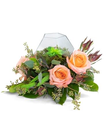 Super Natural - TMF-698 - Super Natural is a dazzling flower design with elegance, spice, and sass. Perfect for any occasion or just because. Super Natural is a magical flower arrangement featuring romantic and timeless roses, beautiful leucadendron, recognizable seeded eucalyptus, and popular modern accents of a succulent surrounded by moss and curly willow. As an added bonus to the already perfect floral design arrangement of the choice of flowers and succulent, it is placed in a uniquely designed prism bowl. Approximately 12&quot; wide by 8&quot; high