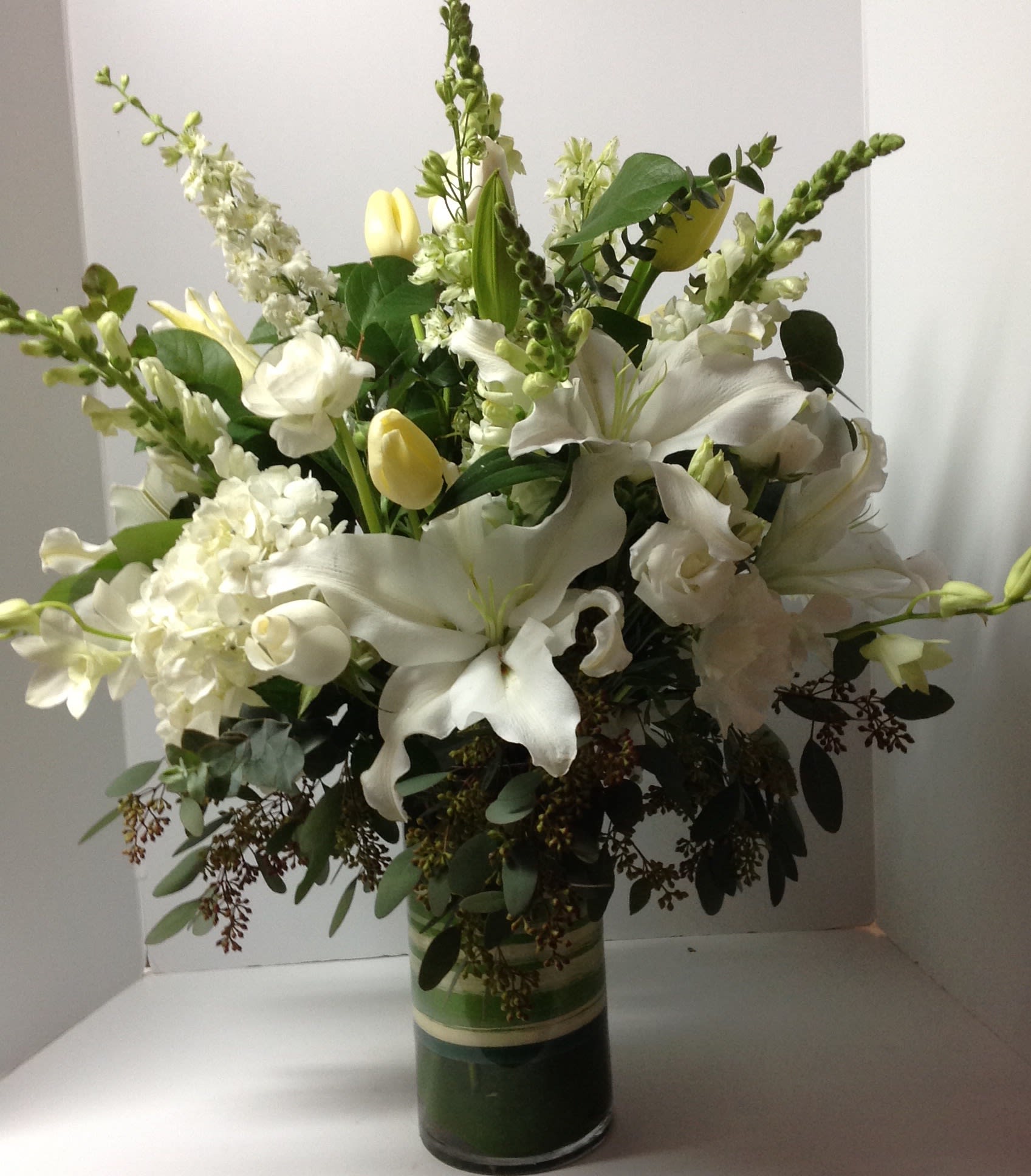 Peaceful White - A beautiful floral arrangement with mixed flowers.  Flower selection subject to availability.