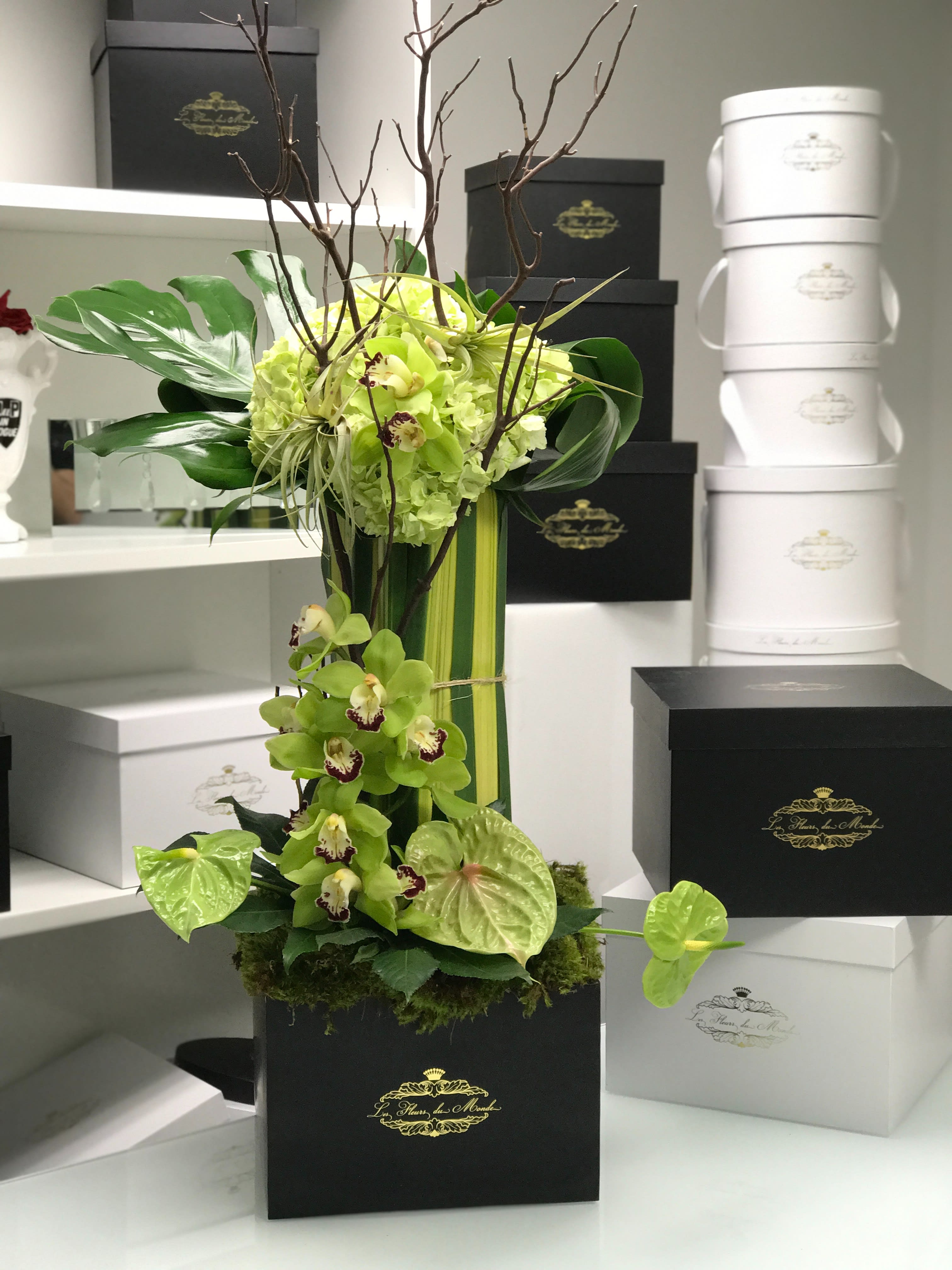 la tour la tour - la tour (The tower) is a beautiful display of cascading cymbidium orchids, curly willow branches, monstera greenery, natural moss and anthuriums. This grand display will take your guests breathe away! perfect for events or upscale dinner affairs, lobby display, or a grand way to show that special someone how much they truly mean!