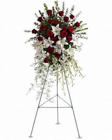 Lily and Rose Tribute Spray - Pure white lilies and dendrobium orchids mingle with red roses white asiatic lilies and more in this magnificent and impressive standing spray of the finest blooms. A fitting tribute for a funeral wake or memorial service.