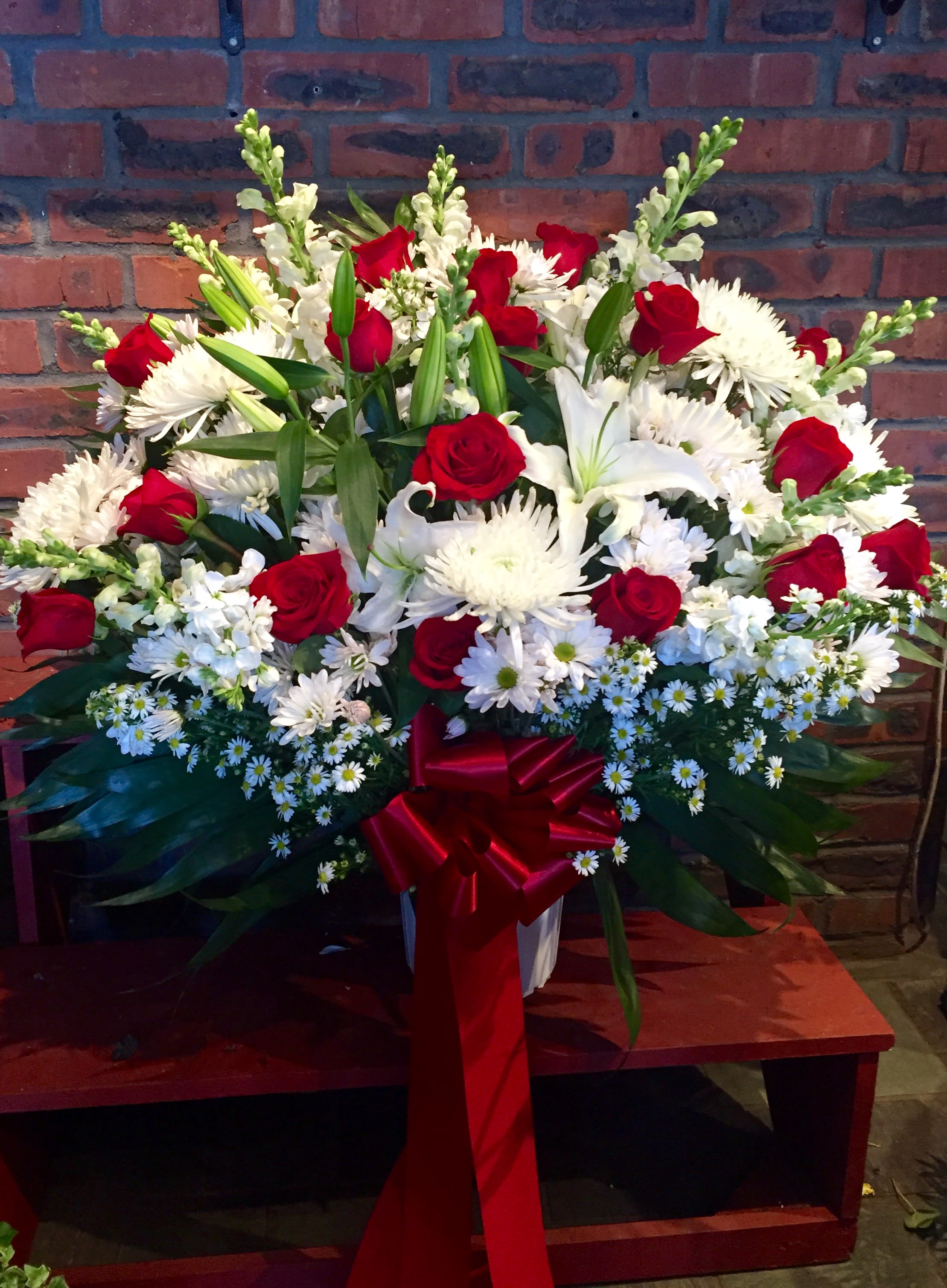 Traditional standing basket - Red and white flowers featuring red roses, white lilies, white daisies and snap dragon