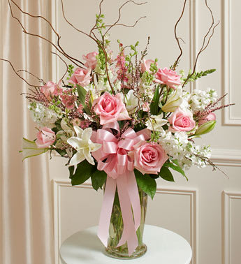 Beautiful Blessings Pink Vase Arrangement - Product ID: 91299   Send a message of comfort during times of sorrow with this beautifully designed arrangement. Our expert florists take fresh pink and white blooms to craft a breathtaking tribute that perfectly conveys your deepest sympathies to family, friends or co-workers. Hand-designed arrangement of fresh pink roses, white hybrid lilies and more Accented with salal, curly willow and more Presented in a classic clear glass vase; measures 11&quot;H Can be delivered directly to the funeral home or the home of the family Our florists choose only the freshest flowers available, so colors and varieties may vary Arrangement measures approximately 28&quot;H x 30&quot;L