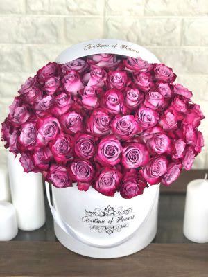 60 purple roses on round box by Rubi's Flower Shop