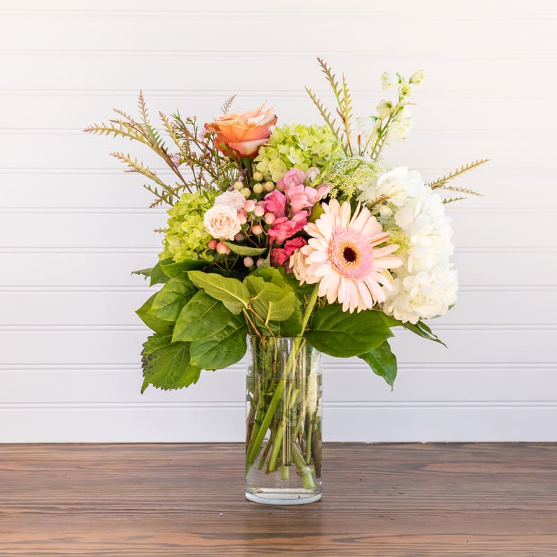 Sweet Cream - A beautiful assortment of peaches, pinks and whites with a few berries and several types of greenery thrown in. The soft tones in this arrangement make it slide seamlessly into any color scheme, and this would look lovely in any home or business lobby.
