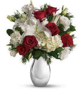 Teleflora’s Silver Noel Bouquet    - The lovely Christmas bouquet includes white hydrangea, red roses, white oriental lilies and white lisianthus accented with flat cedar. Approximately 14 1/2&quot; W x 17&quot; H