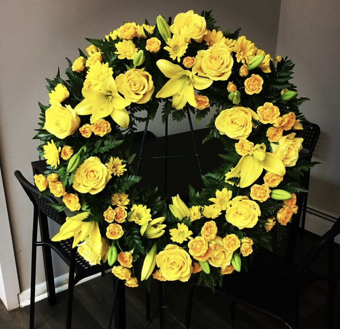 Yellow wreath - Sympathy wreath to send to the viewing. Seasonal yellow flowers on the standing easel.