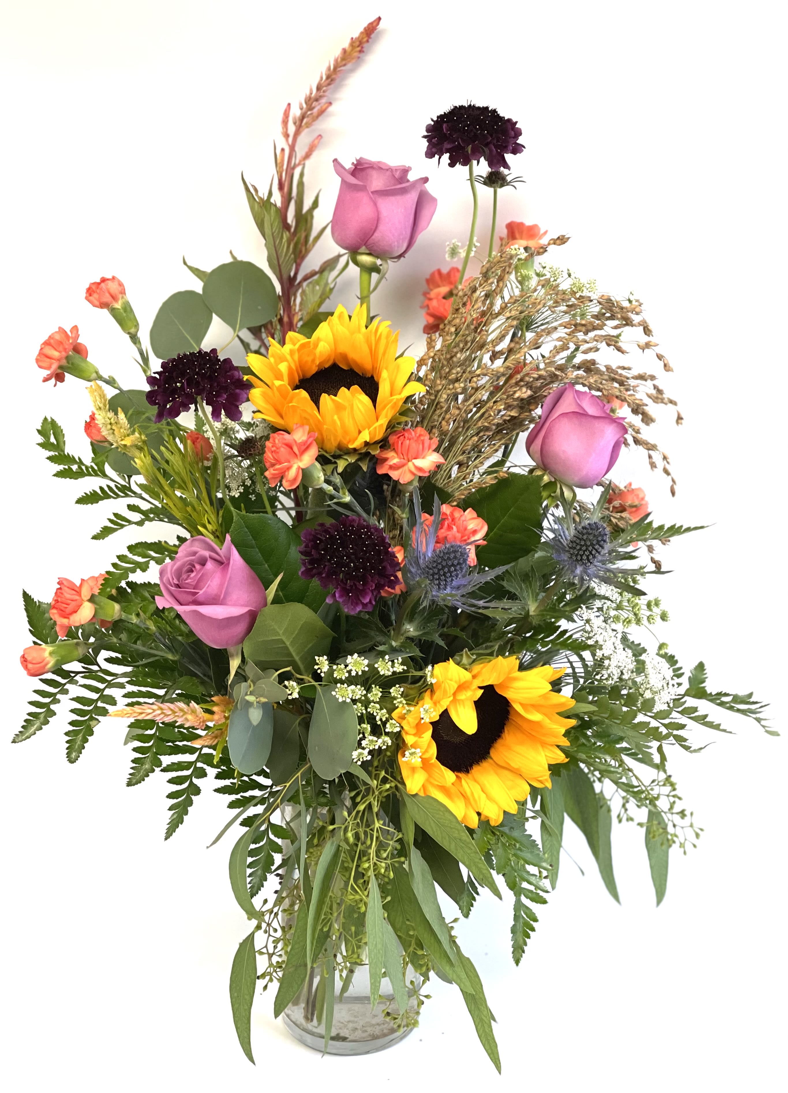 Glowing Fall Bouquet by Barb’s Flowers Glowing Fall Bouquet by Barb’s Flowers - This beautiful is perfect for the Autumn season. Tell someone Fall is here with this beautiful glowing bouquet. Sunflowers, Lavender Roses, Orange Mini Carnations and other seasonal flowers and fillers.