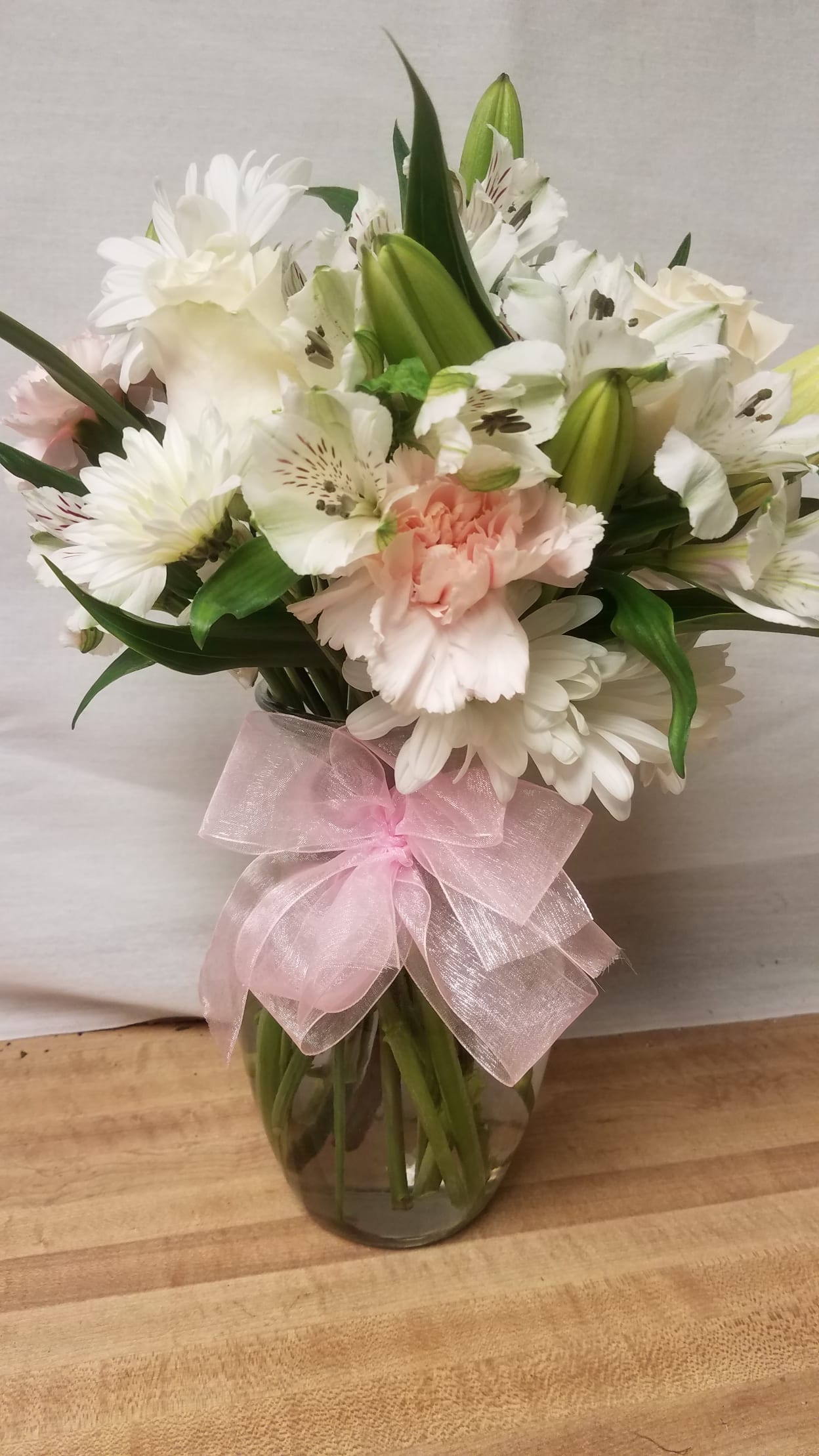 Expression of Sympathy - A vase of white blooms with some pink carnations that will include roses and alstromeria