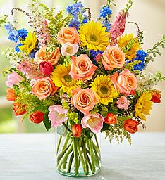 Spring Sensation - Warm sunshine, crisp air, vibrant colors. Spring is a time to stop and enjoy all the beauty around you, and this gorgeous bouquet is no exception! Featuring pink, blue, yellow and peach blooms artistically hand-designed by our skilled florists, this luxurious, full arrangement delivers the best part of the season right to their door!