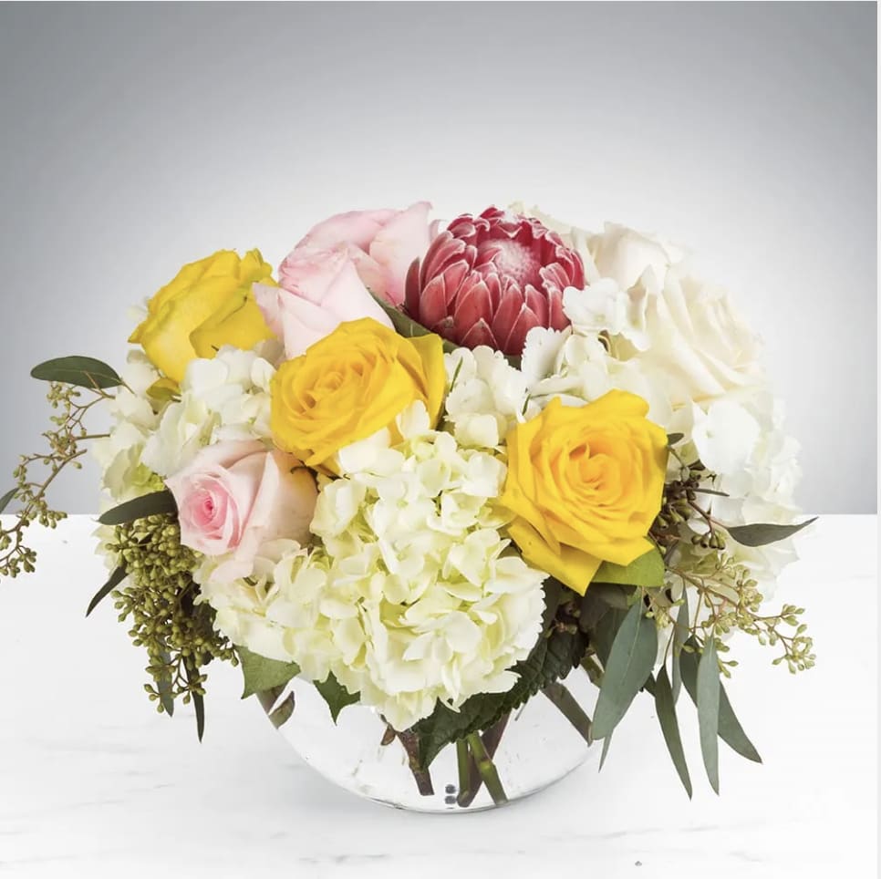 Hello Love by BloomNation™ - The Pink Ice Protea create brings a hint of the tropics in this classic bouquet. This arrangement includes roses, hydrangea, and a pink ice protea. It is the perfect gift for a Birthday,Thank You, or Just Because. APPROXIMATE DIMENSIONS: 11&quot;D X 11&quot; H