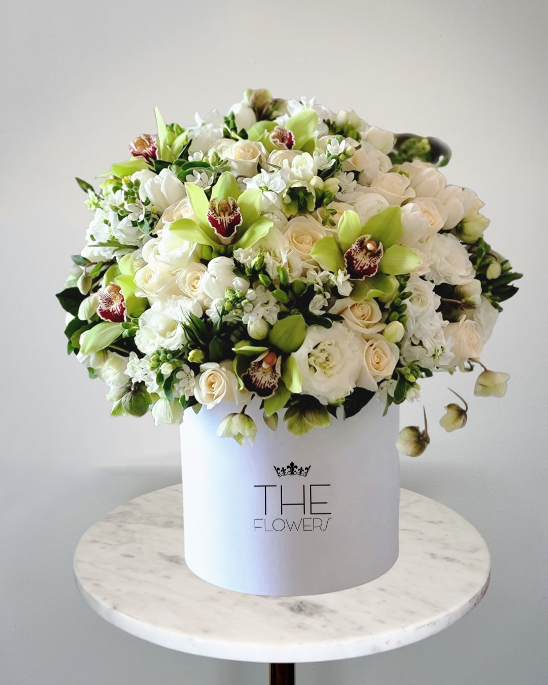 Beginning Of Life - The composition with white dahlias, rununculi and green orchids looks fresh and relevant in any season. The bouquet will decorate the office, beauty salon, spa, showroom or coffee shop. It will fill the room with an atmosphere of freshness, tranquility, peace, which carry white and green shades.