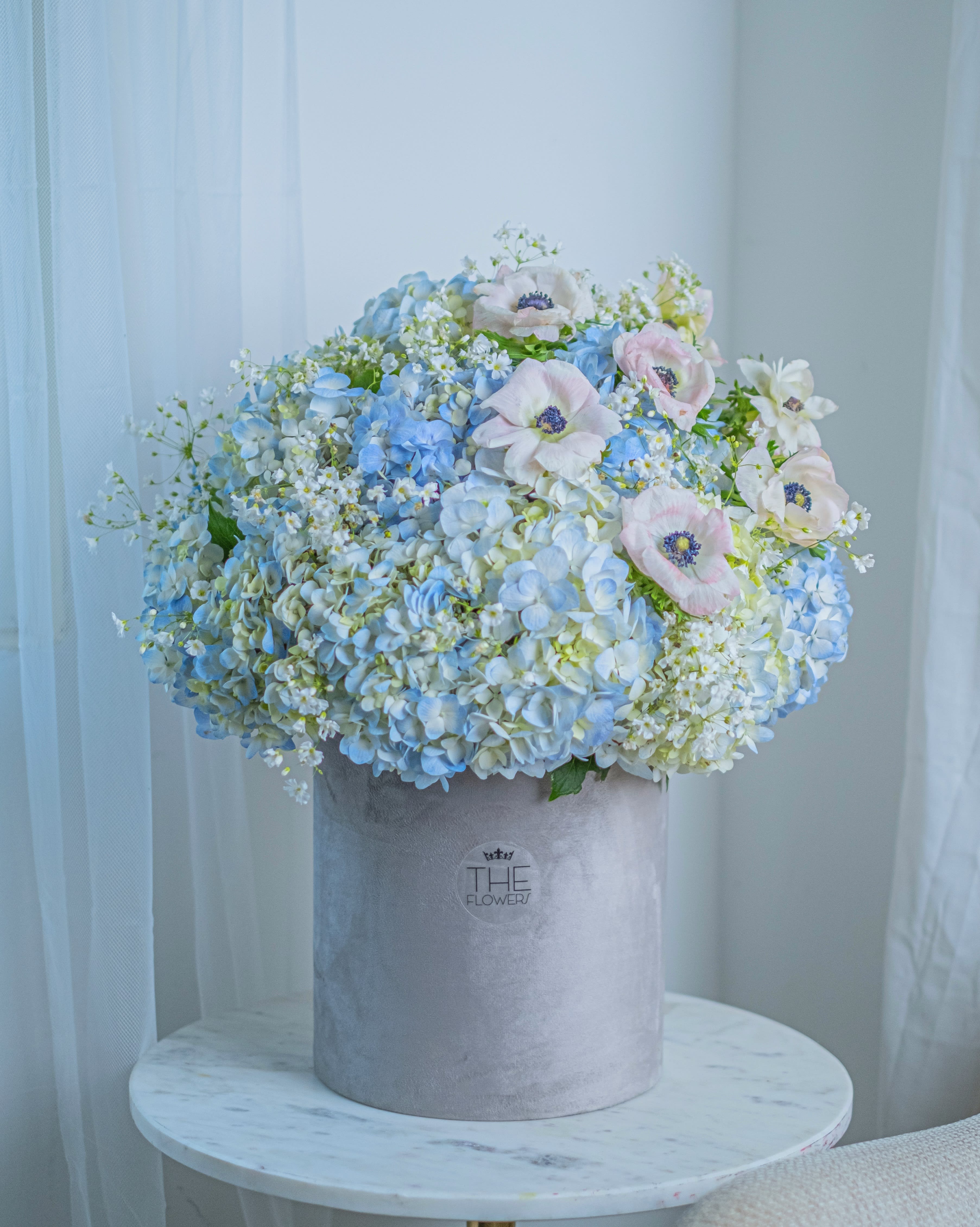 Fluffy Cloud of Hydrangeas  - The Ecuadorian Hydrangeas used in our bouquets are fluffy, cloud-like fragrant inflorescences with hundreds of petals. Complemented with white anemones and small flowers, which gives the composition even more airiness.
