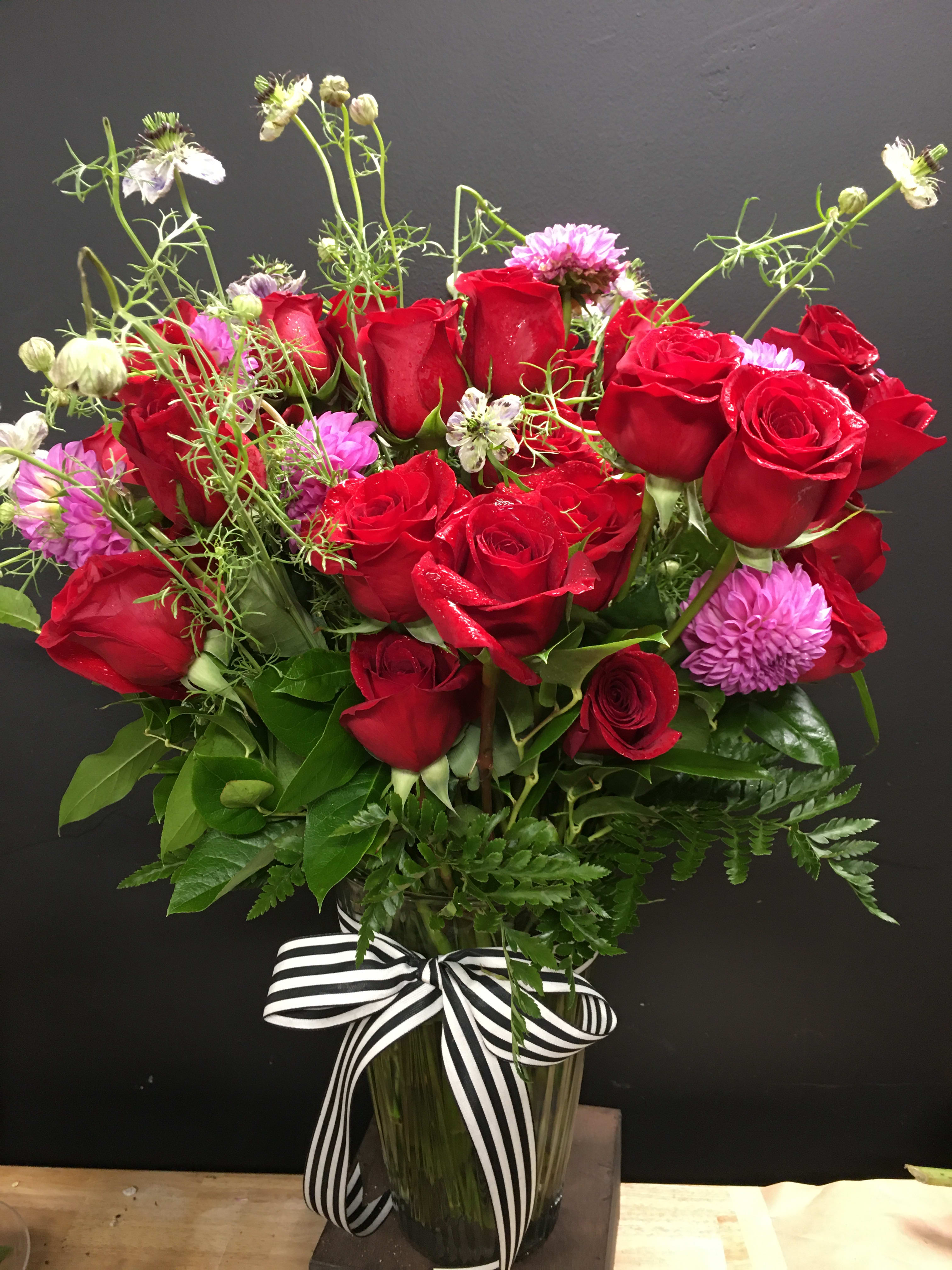 Robena - Three dozen roses highlighted with dahlias and a touch of whimsy in a vase.