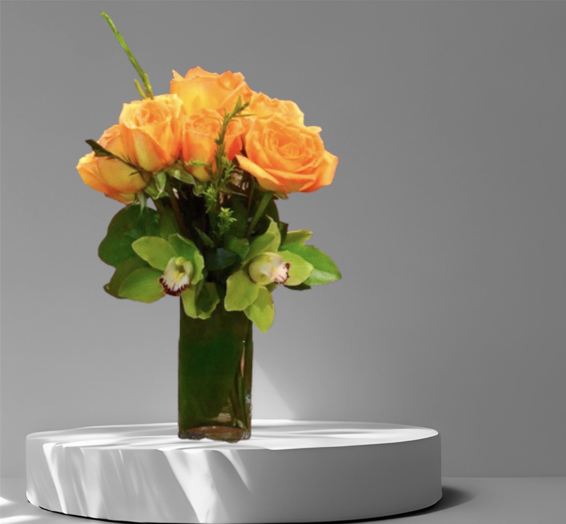 Rose Sunset - One dozen orange roses with green orchids in a glass vase.  Standard- one dozen  Deluxe- two dozen  Premium- three dozen   