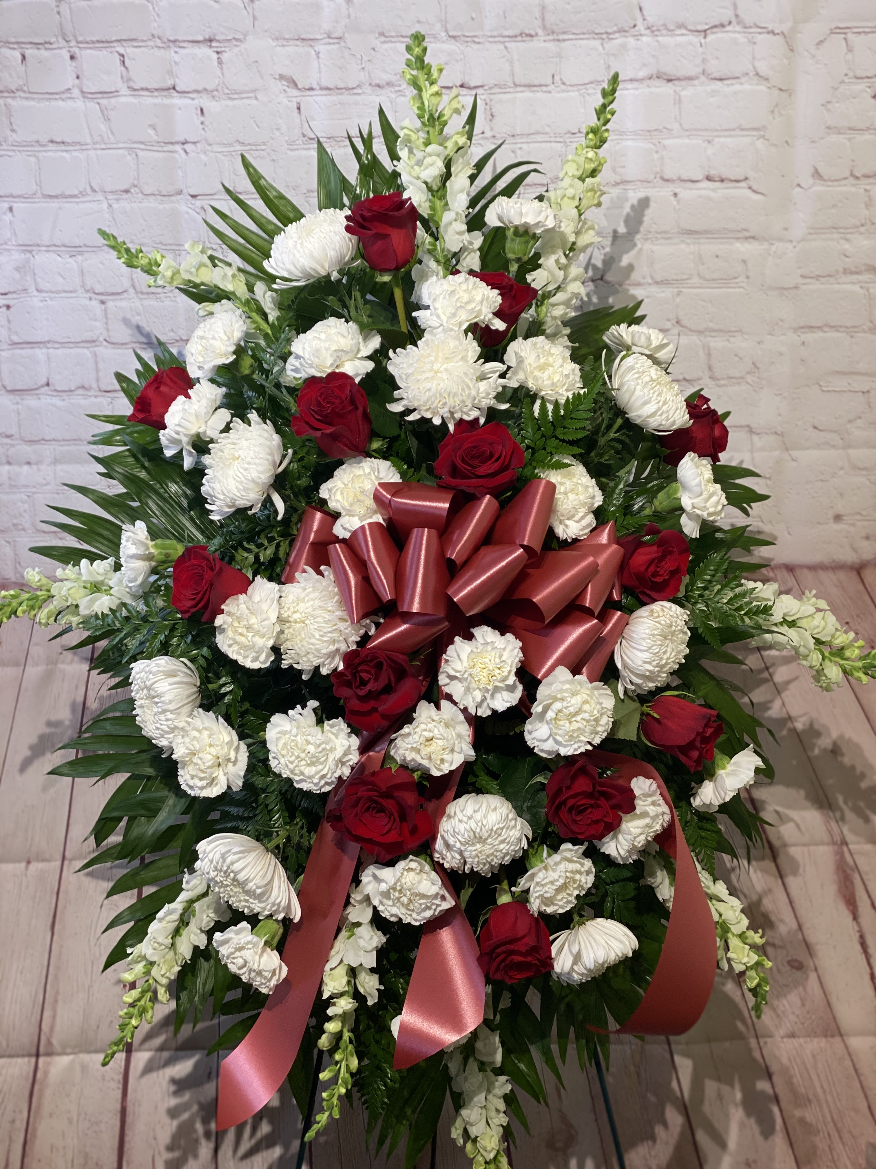 In Loving Memory Standing Spray - Honor your loved one with an impressive red and white display.  Including over a dozen stunning red roses, this standing spray will express your enduring love  approximately 28&quot; W x 40&quot; H 