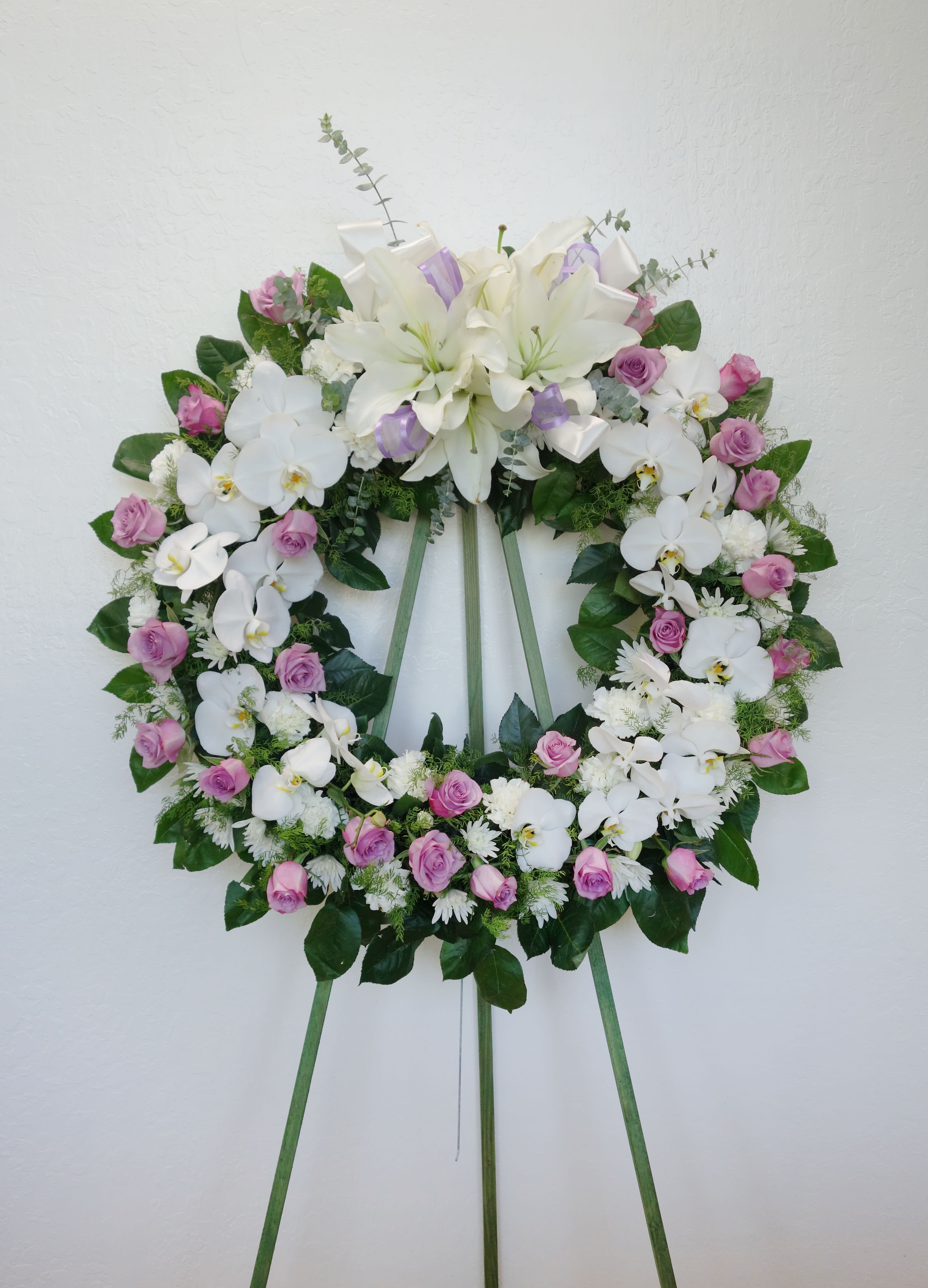 OW#01 Purple Rose Orchid Wreath  - Circle wreath of white phalaenopsis orchids, white asiatic lilies, white carnations, and purple roses.   Standard: 28&quot; Diameter Deluxe: 32&quot; Diameter (as shown)