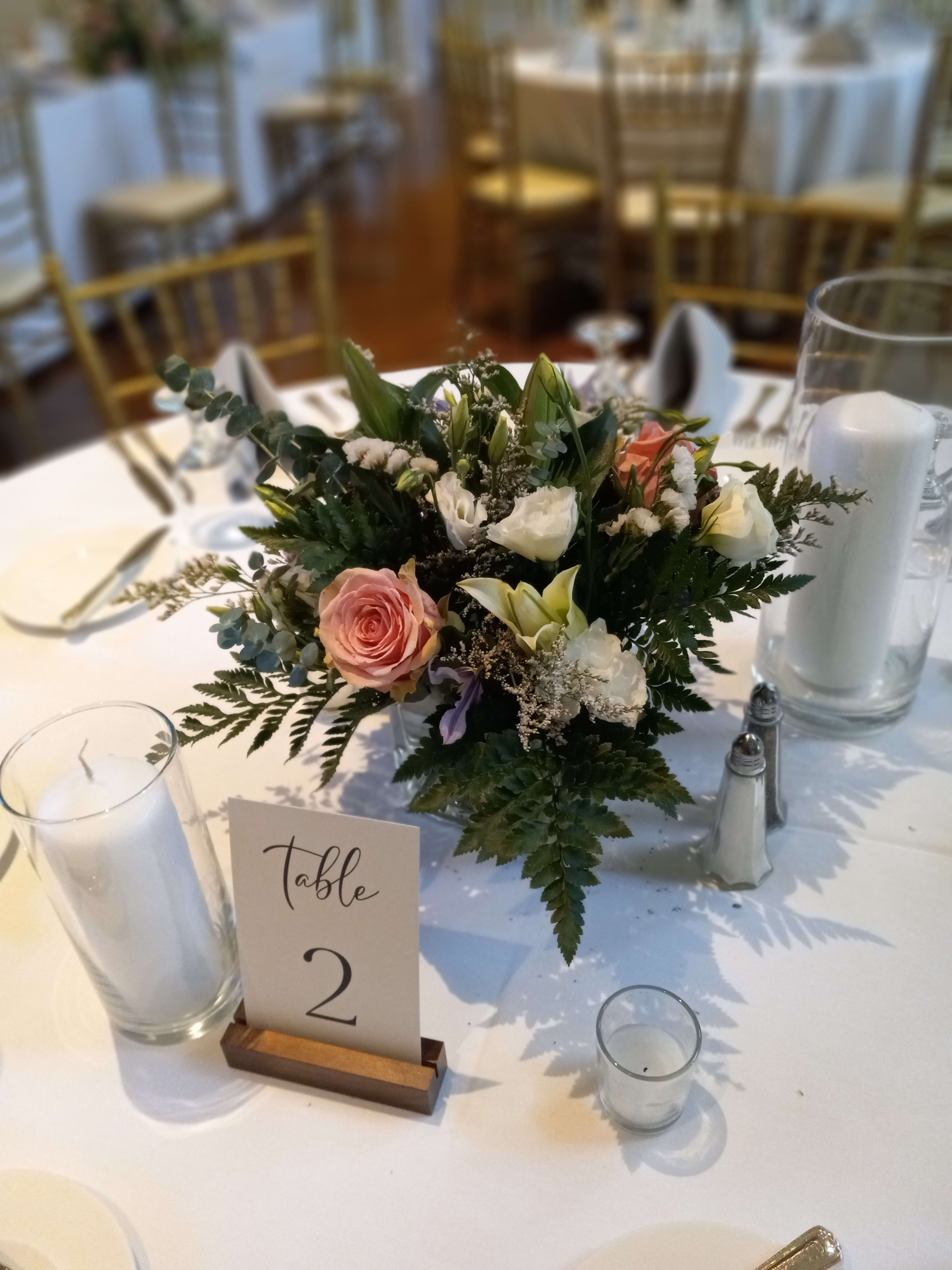 Melissa's wedding reception centerpieces - Beautiful addition to the reception, traditional mix ot flowers matching the bridal party bouquets flowers