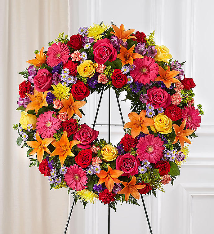 Cherished Garden Wreath - Our bright vibrant mixed color funeral wreath is filled with beautiful blooms of the freshest flowers. Made with care at the flower shop our designers hand pick the freshest blooms in stock to make this eternal wreath compete with love and care.