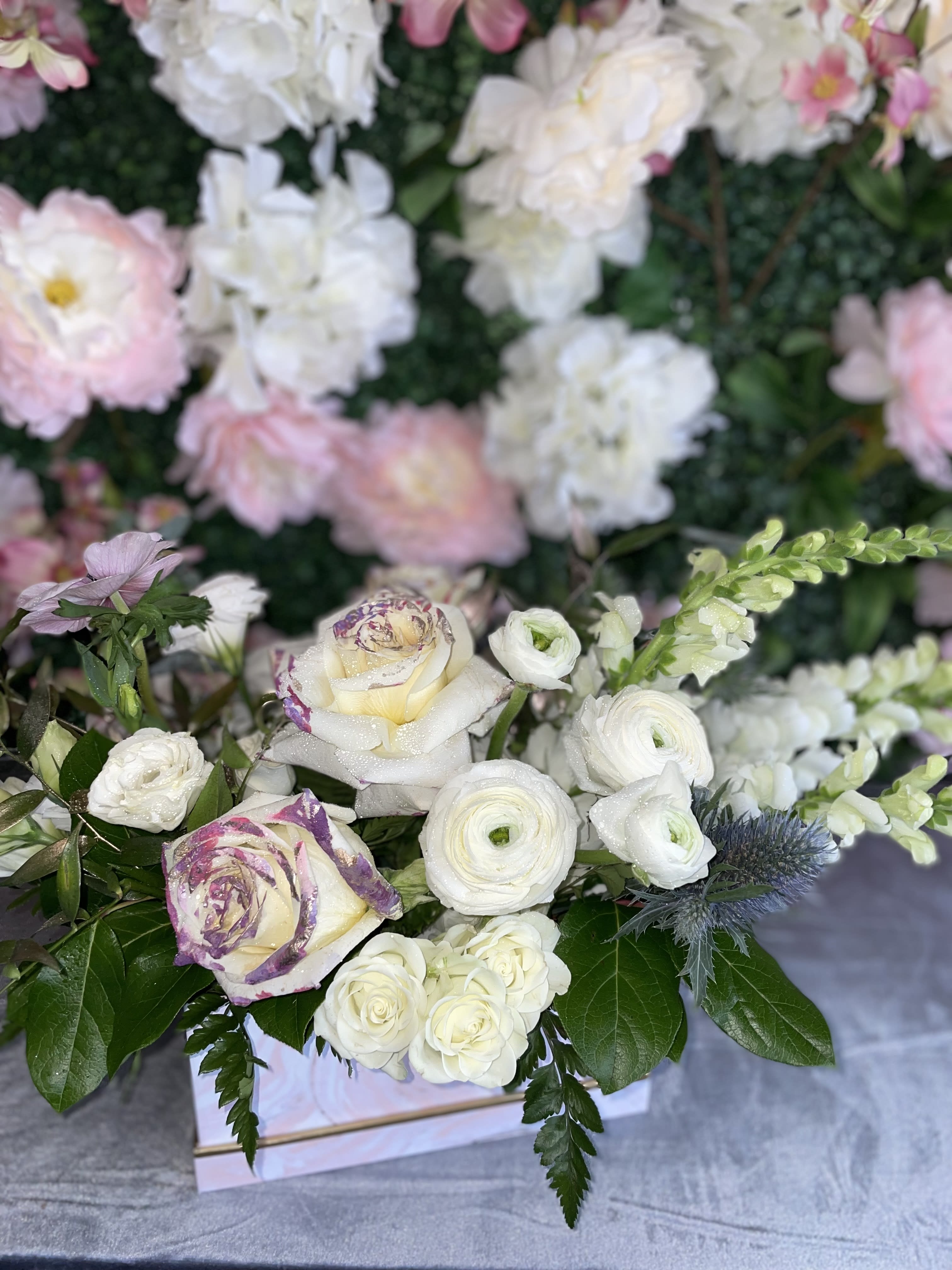 Blooms  - This perfect gift of flowers jas some premium white flowers, white roses, white snapdragons, ranunculus, anemones, and fresh-cut greens. 