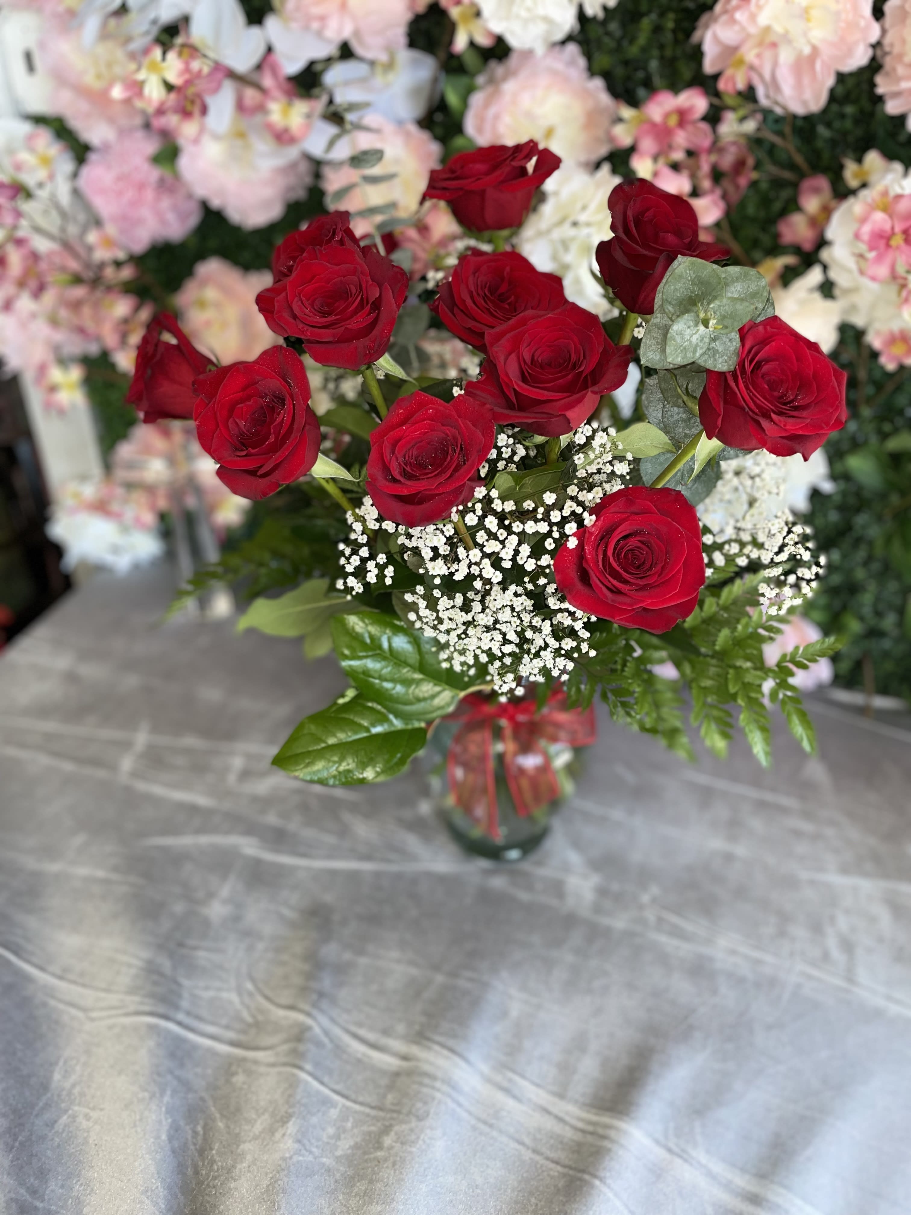 Red Freedom  - This gorgeous arrangement has red roses and fresh greens.