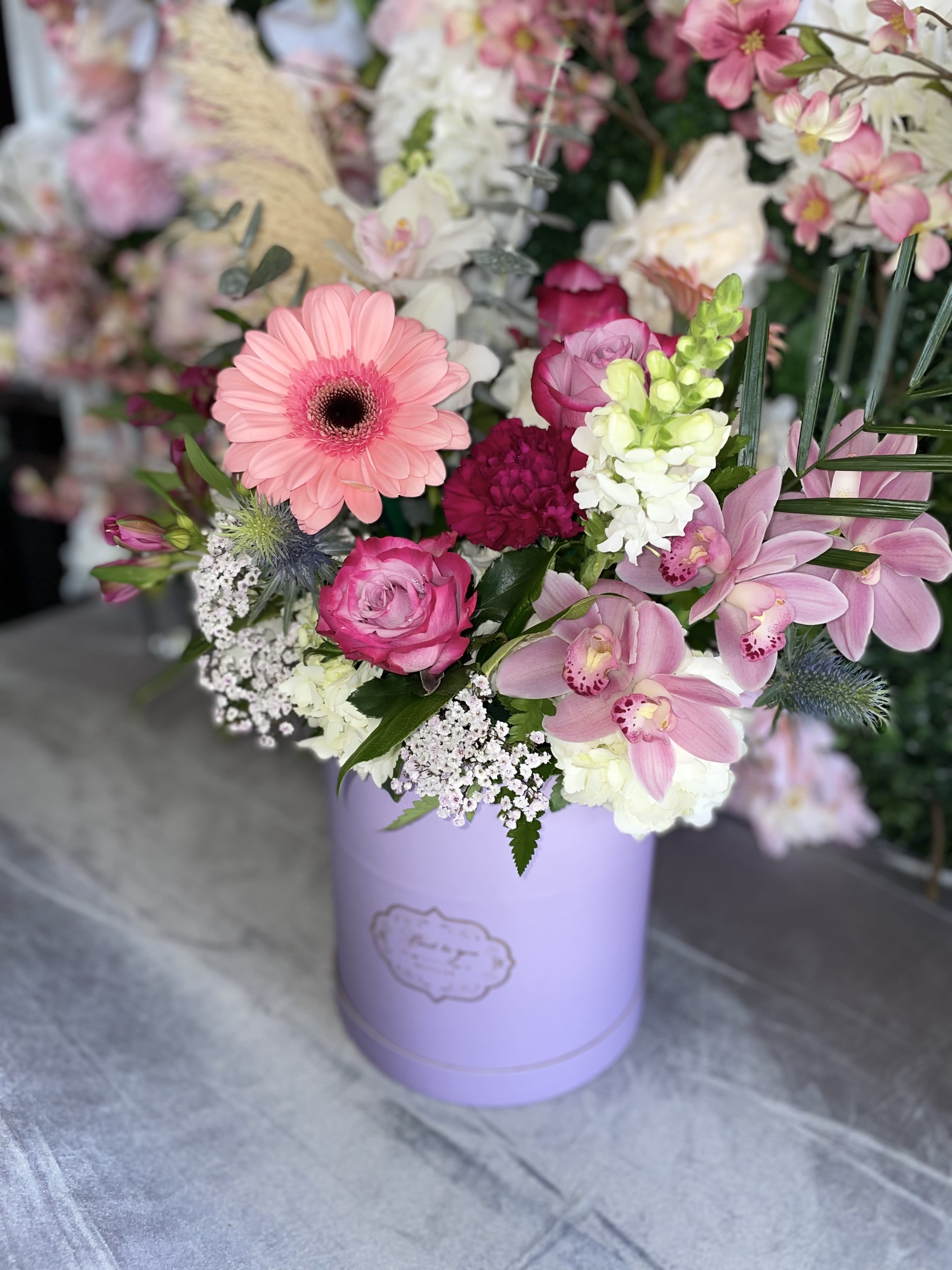 Spring Fresh  - This beautiful arrangement has the perfect colors, pink gerbera, lavender roses, white snapdragons, white hydrangea, pink orchids, purple alstro, purple carnations and fresh greens.