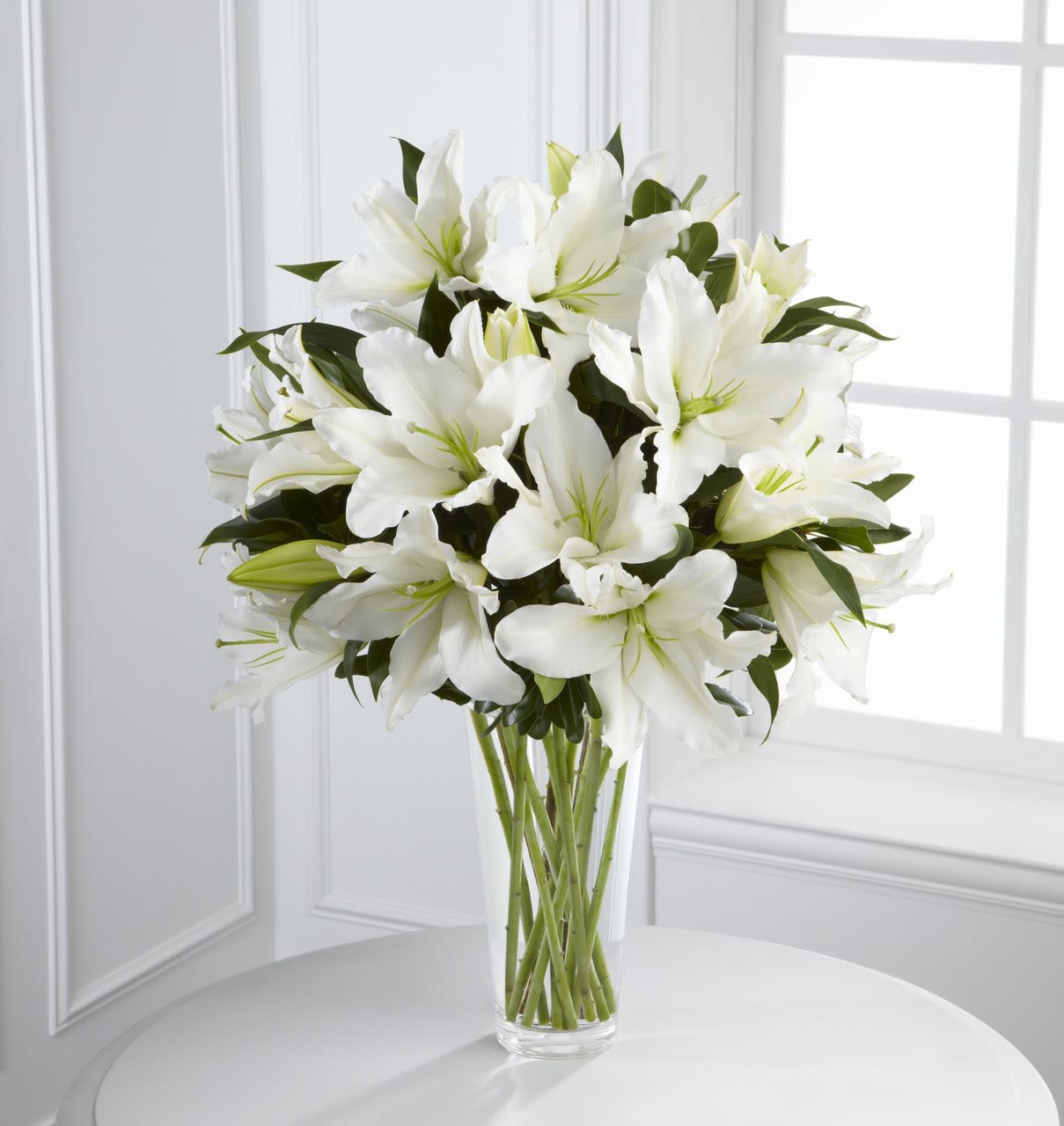 TLSP The Light in Your Honor Bouquet - The Light in Your Honor Bouquet is a beautifully bright arrangement bursting with elegant fragrance to convey your deepest sympathies for the loss of their loved one. A stunning bouquet of gorgeous Oriental lilies are accented with lush greens and seated in a clear glass vase to create a bouquet that is serenely sophisticated, offering comfort and peace in their time of need. GOOD bouquet includes 8 stems. Approximately 22&quot;H x 15&quot;W.  Your purchase includes a complimentary personalized gift message.