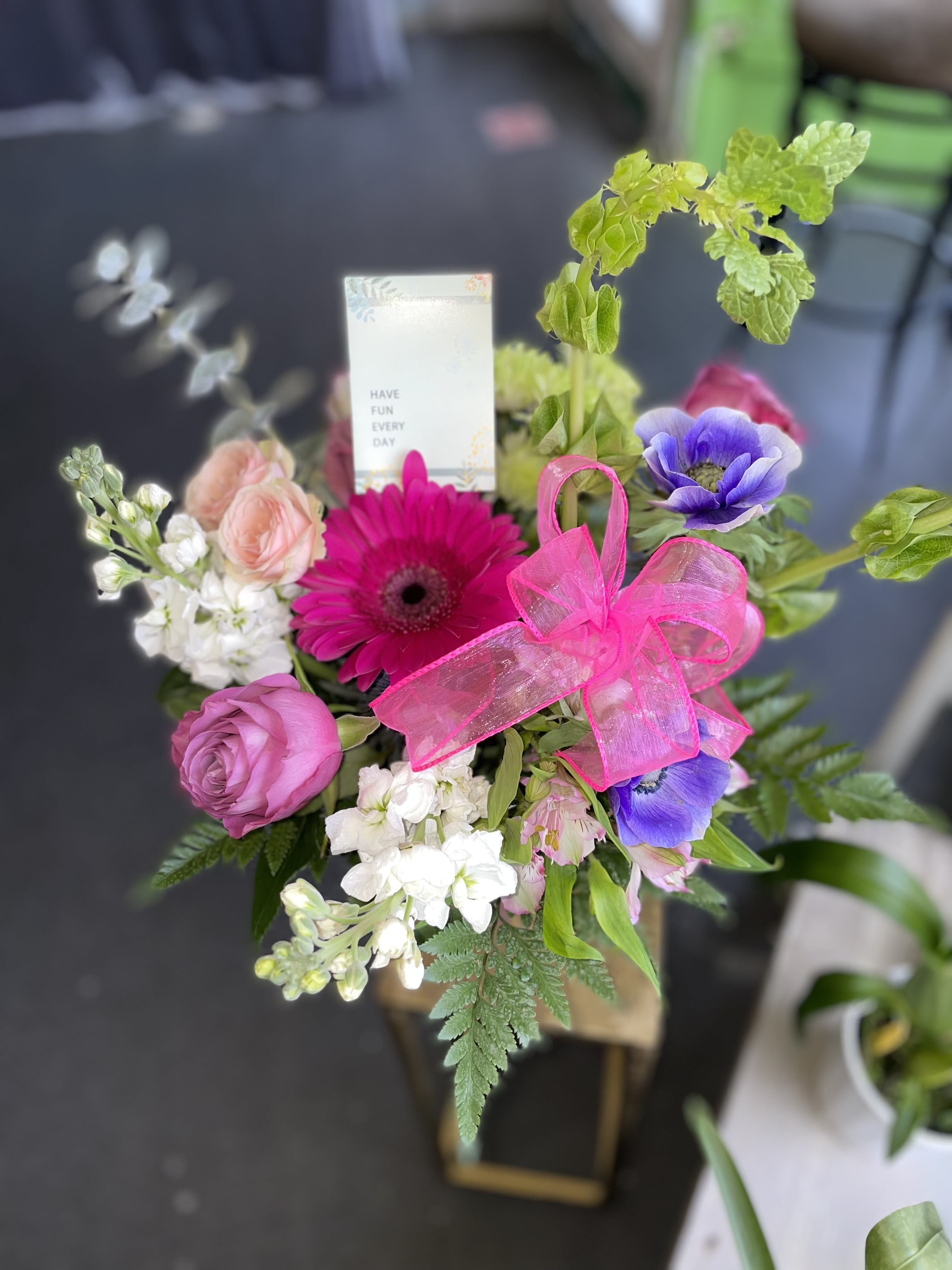 Loving Blush  - This beautiful arrangement has some nice colors and is a perfect gift to toe you love. This arrangement has pink gerbera, lance ser roses, white stock, pink alstro, green pompos, bells of islands and fresh greens. 